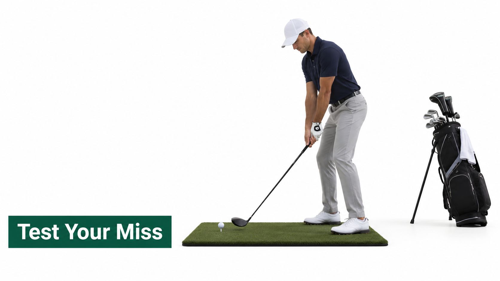 A professional golfer in a white hat addressing a golf ball on a tee on a practice mat.