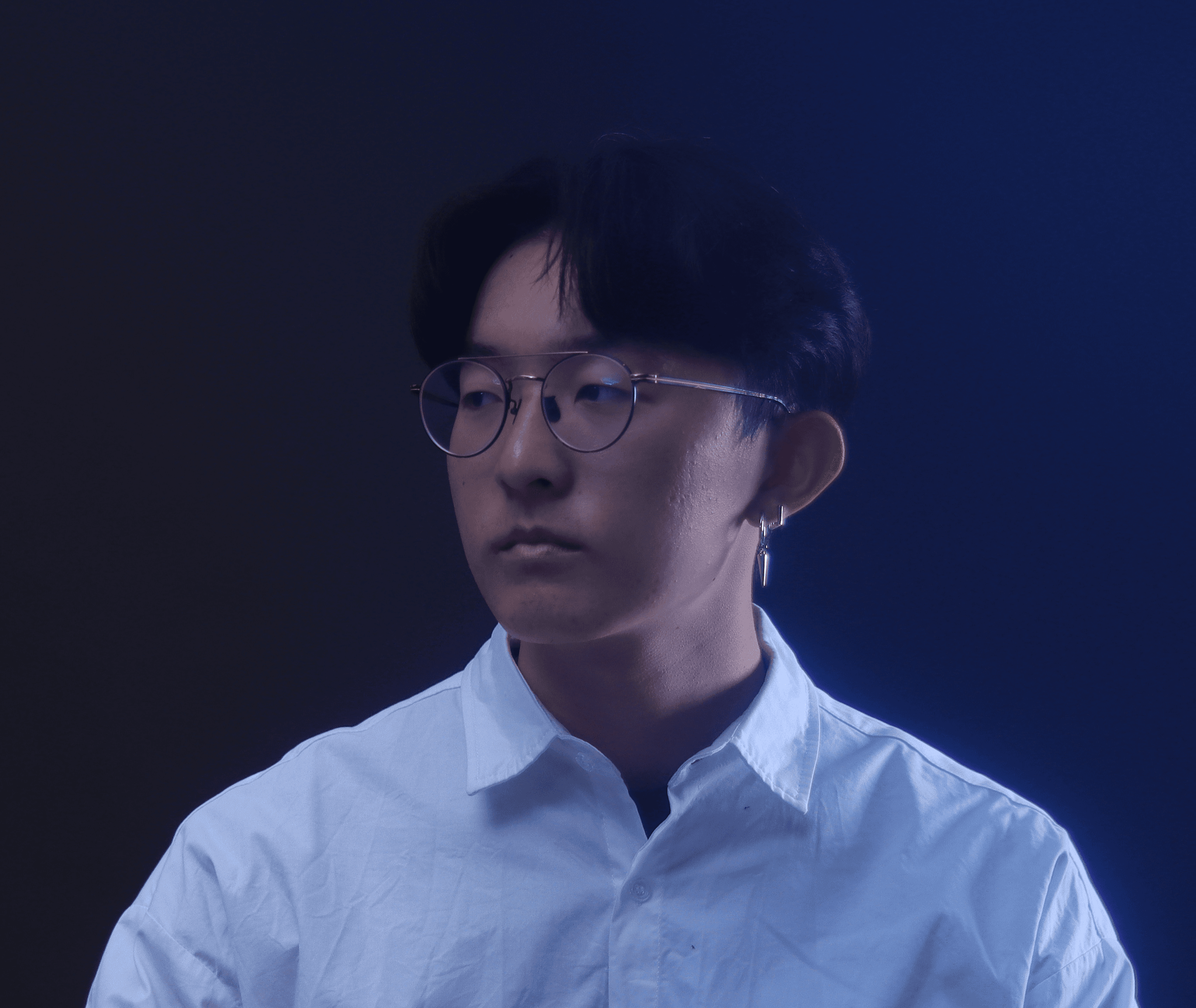 Profile portrait of a man in a white shirt against a light background