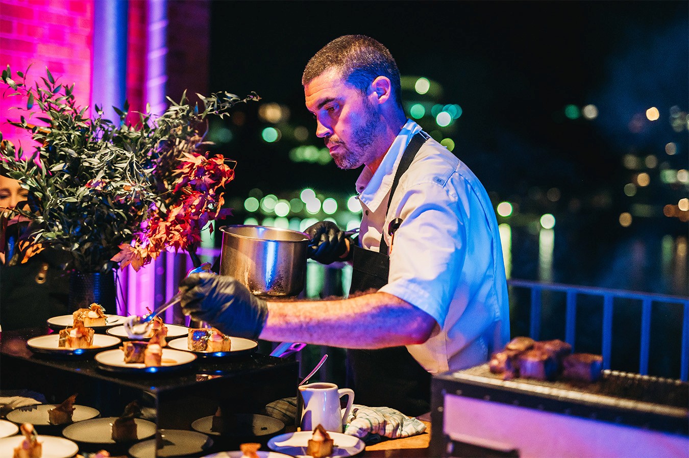 Chef plating up individually plated catering at a Live Station