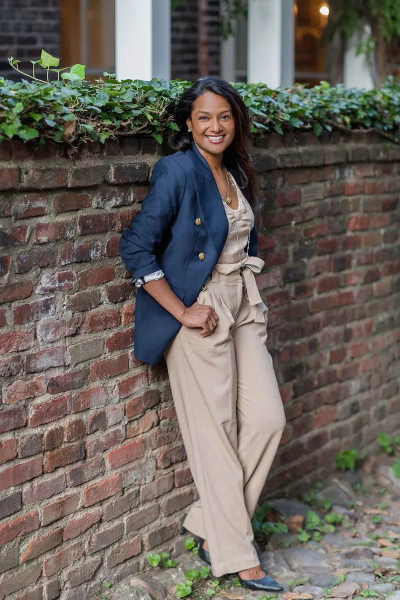 Dr. Rai standing by brick wall for photo