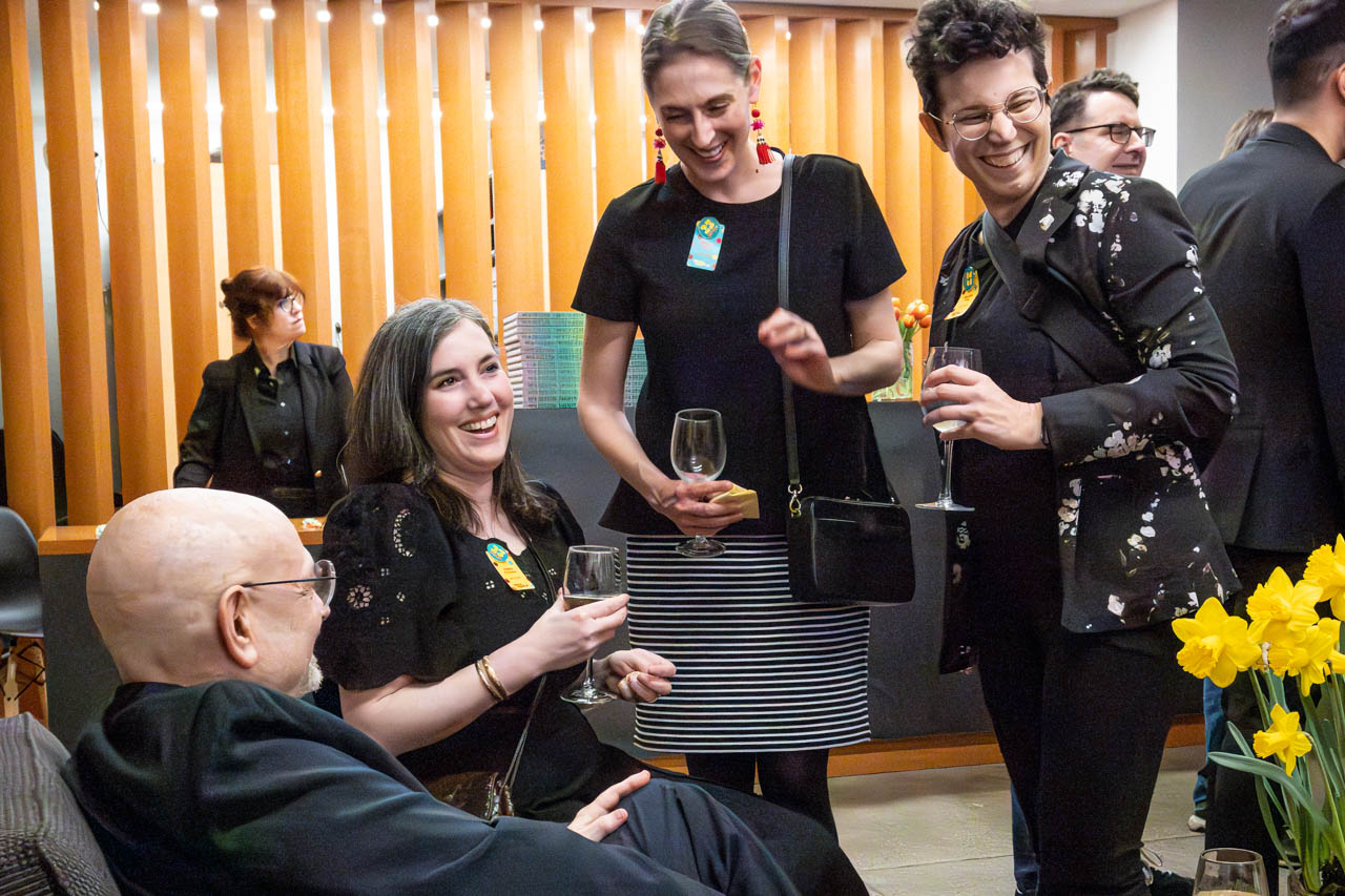 four people at cocktail party chatting