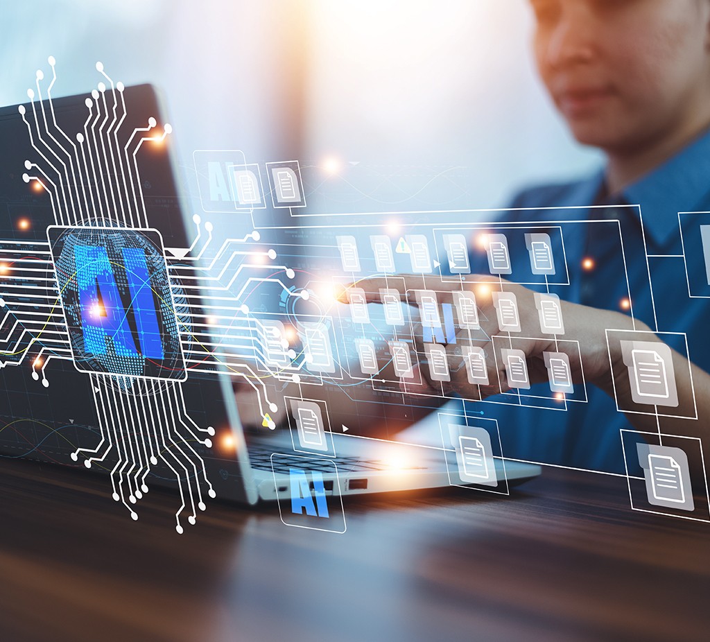 Man at laptop, AI and folder icons floating in the air. A visual representation of the AI working.