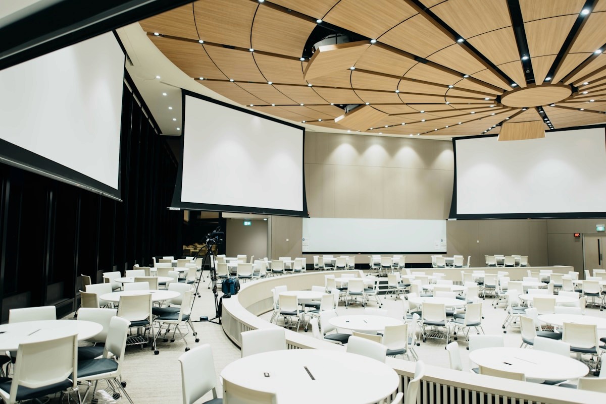 Corporate conference room at Solmere Hall with round tables and projection screens