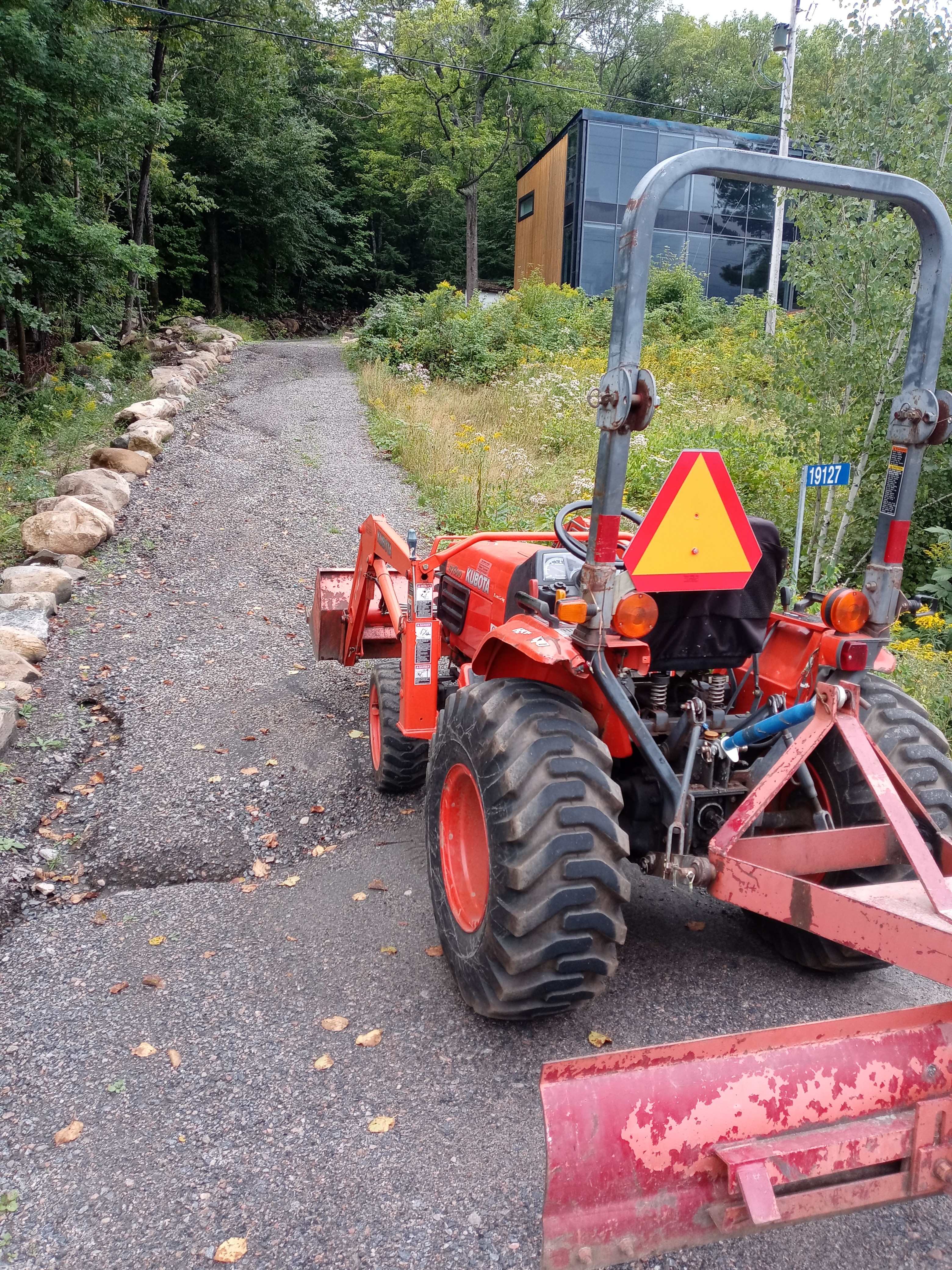 Severely washed-out cottage driveway before regrading and repair.