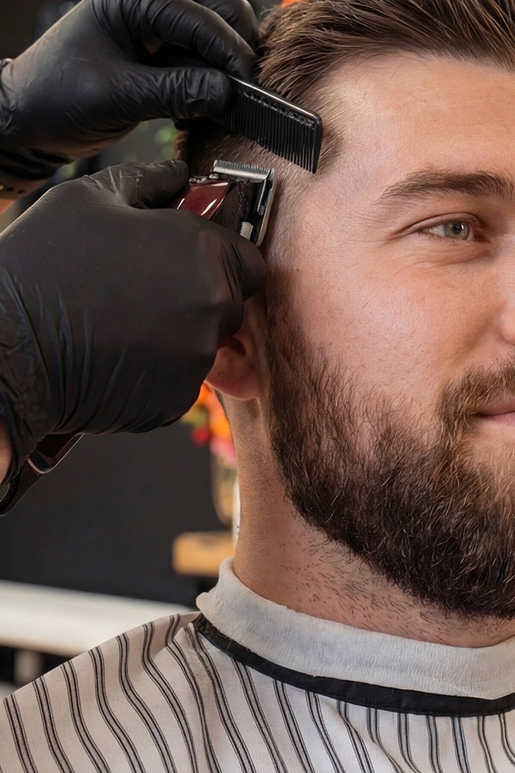 Clipper trimming the back of a man's hair