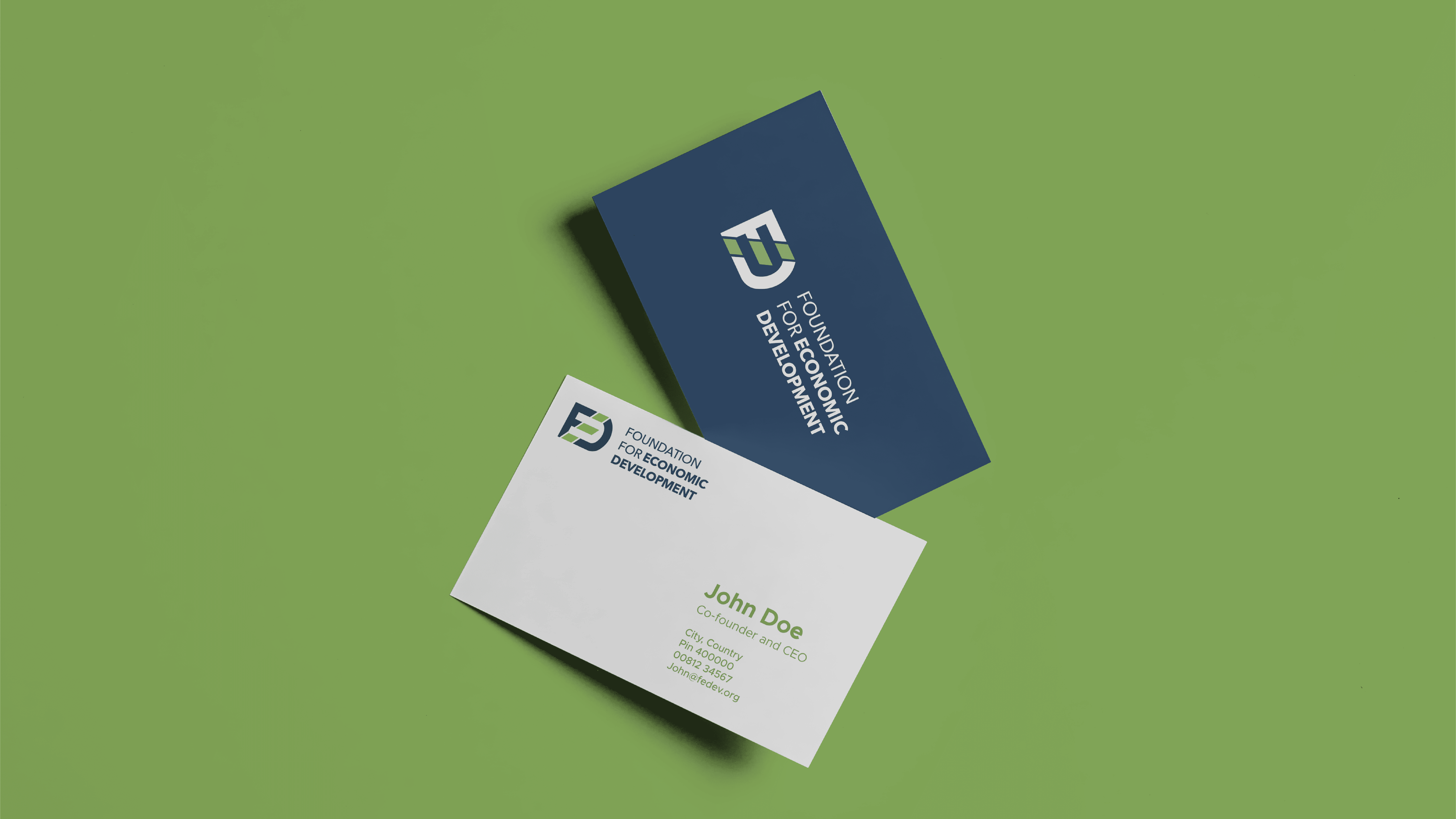 Two business cards for the Foundation for Economic Development on a bright green background, showcasing logo and contact information.