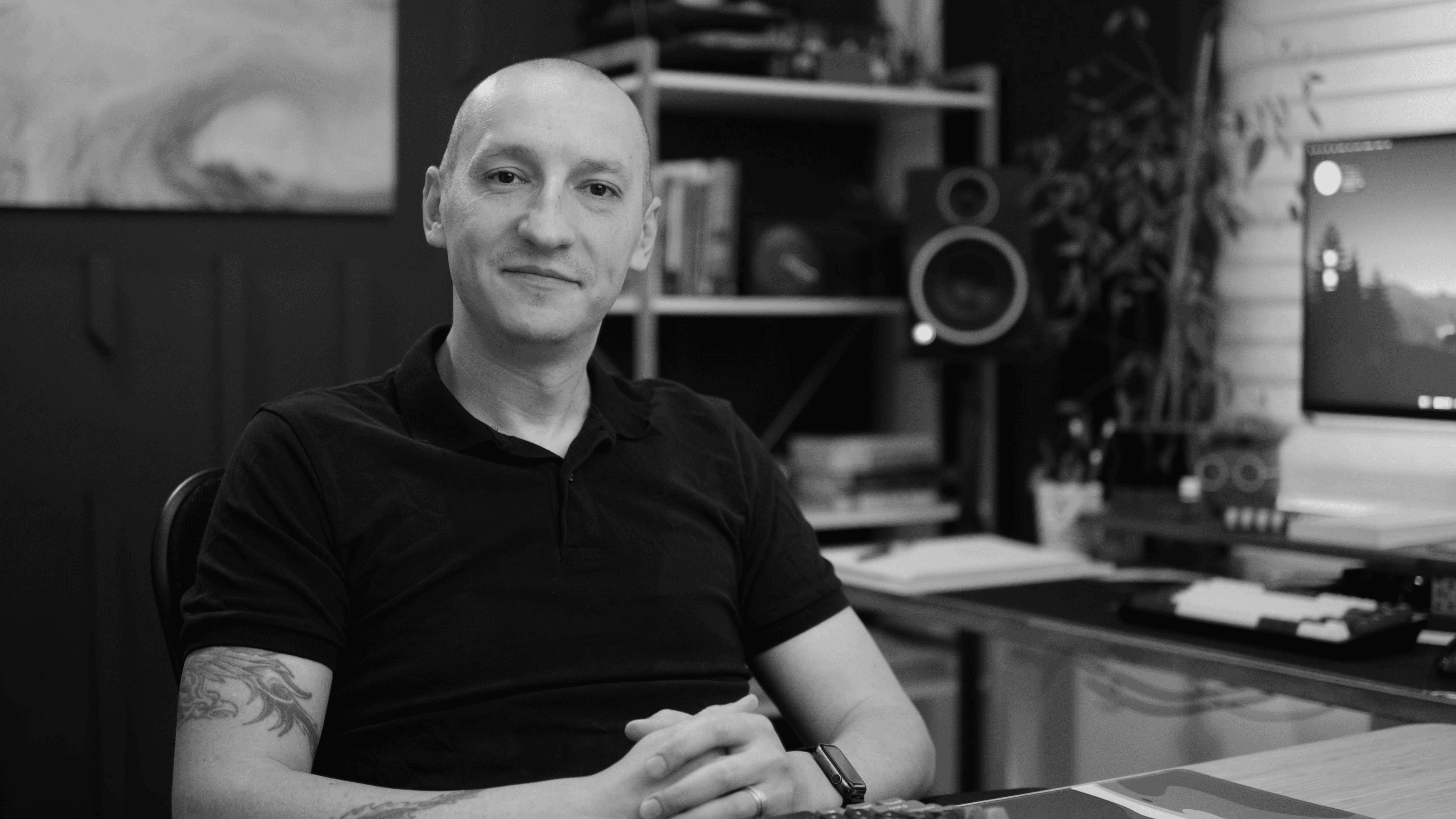 Black-and-white portrait of Adi Purdila at his desk.