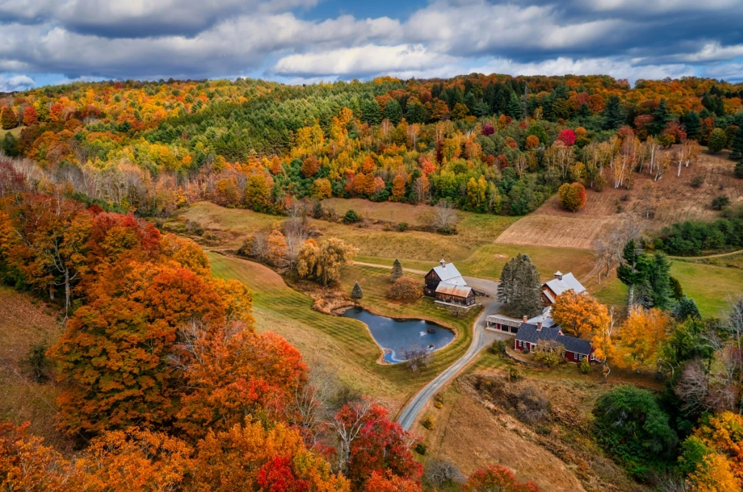 A barn nestled in a valley during fall, VT