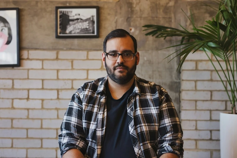 middle aged man with glasses, dark hair and beard, slightly overweight