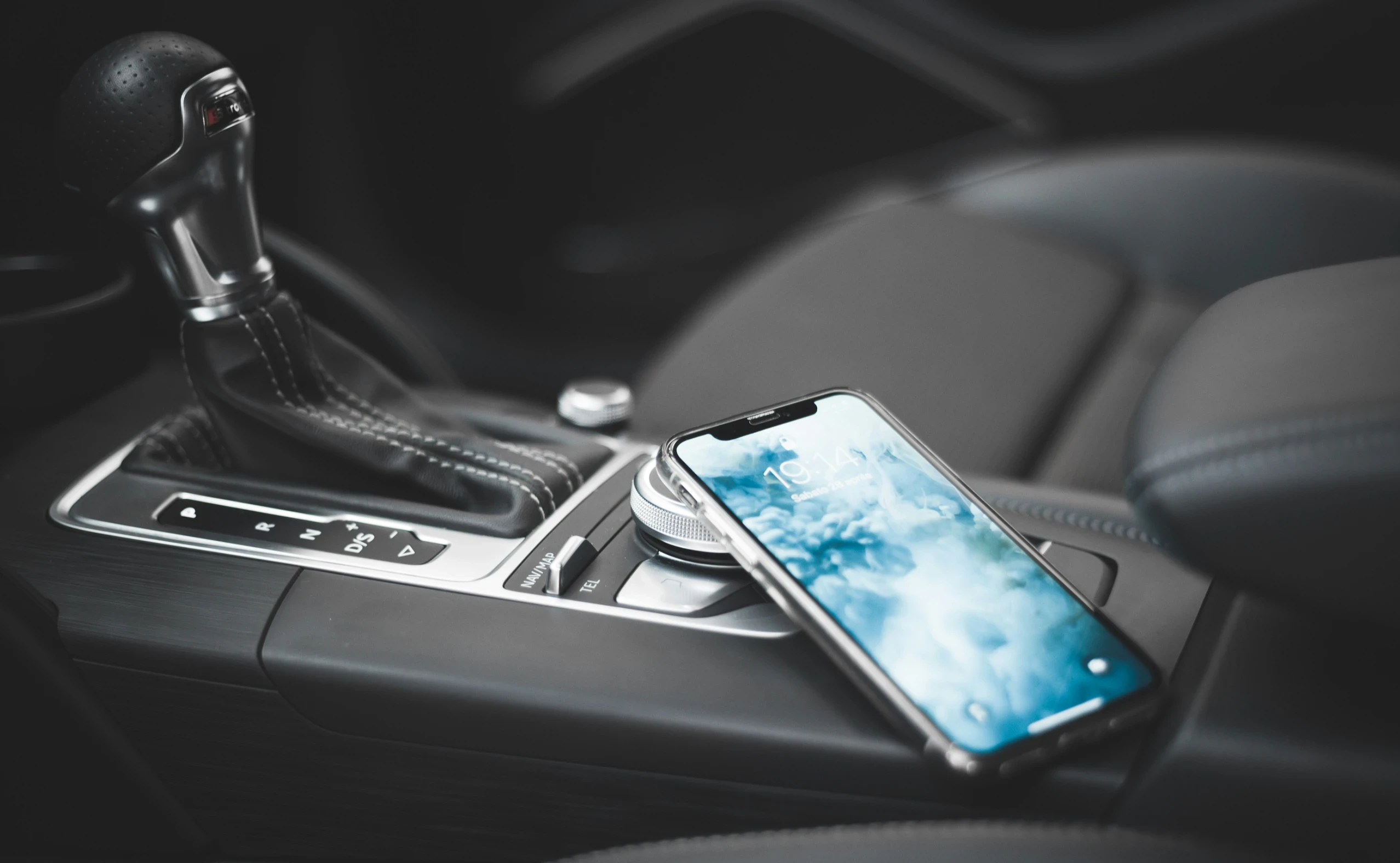a smartphone on the center console of a car 