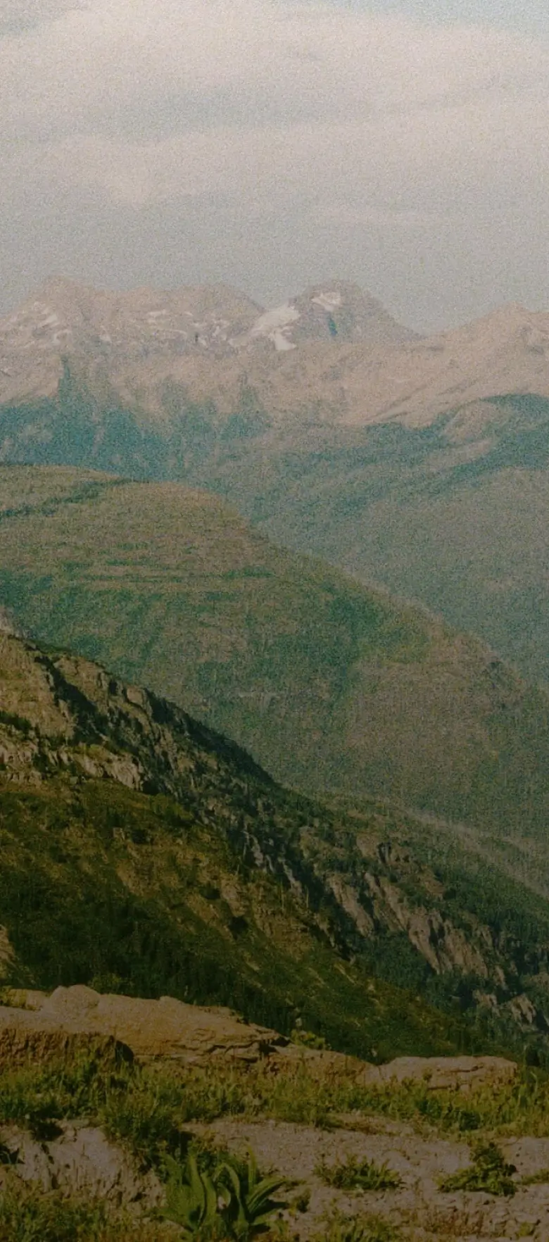 A landscape image on the mountains with a tent near a lake