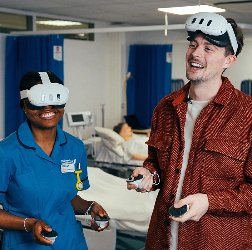 Nurse and instructor using Meta Quest VR headsets for medical training simulation in a hospital ward