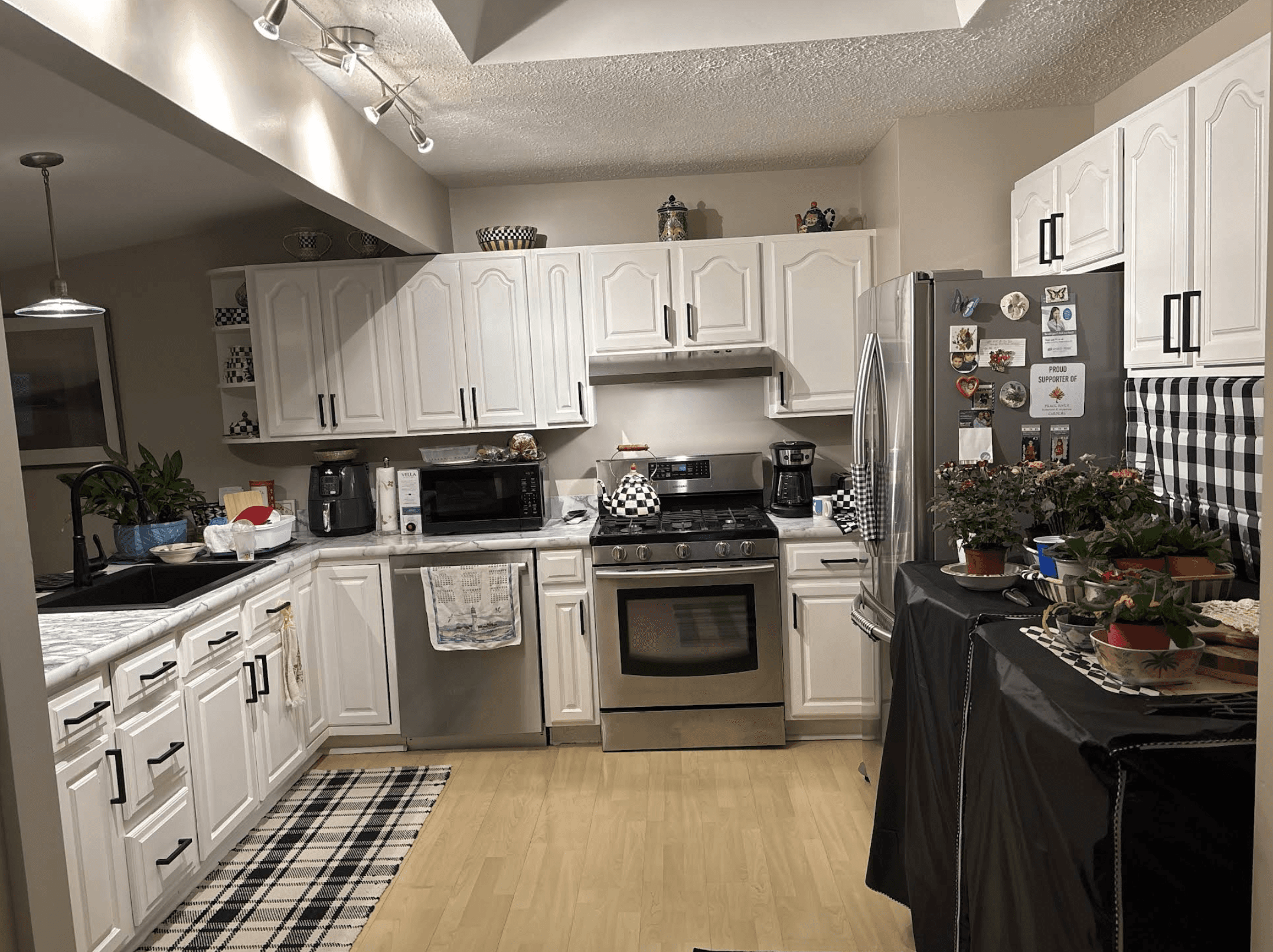 white wooden kitchen cabinet with black pendant lamp