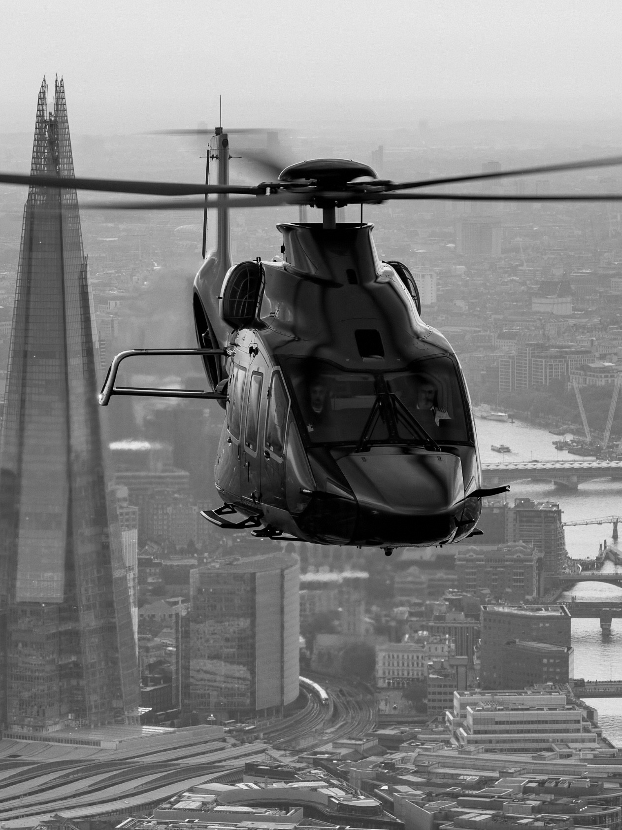 Helicopter flying over London with the Shard building in the background