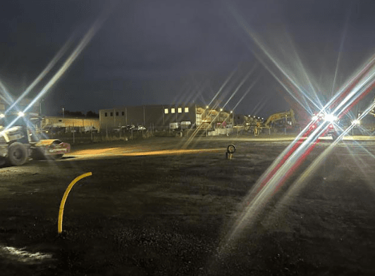 black and yellow heavy equipment on brown rock formation during daytime