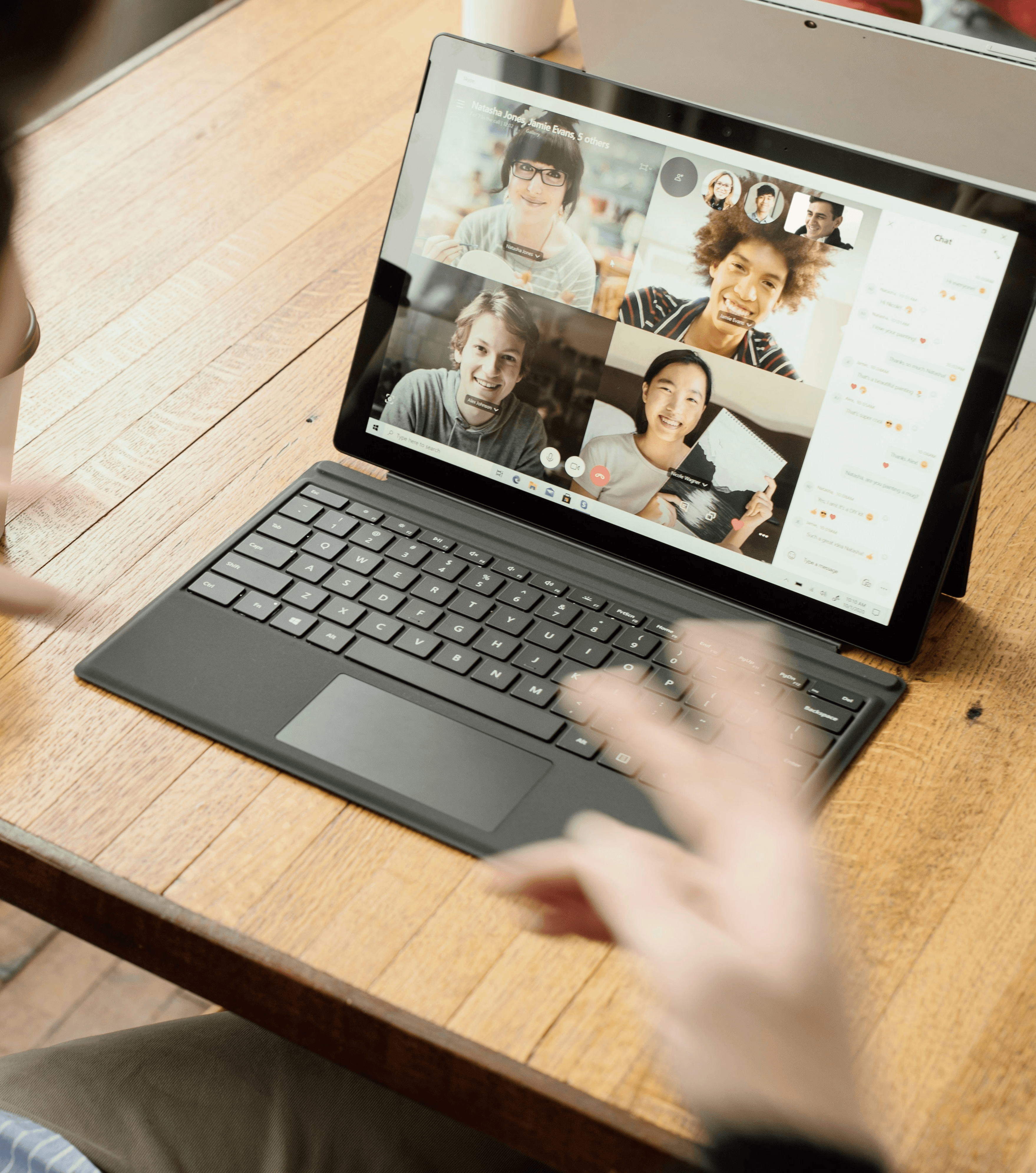 person in blue long sleeve shirt using black Surface
