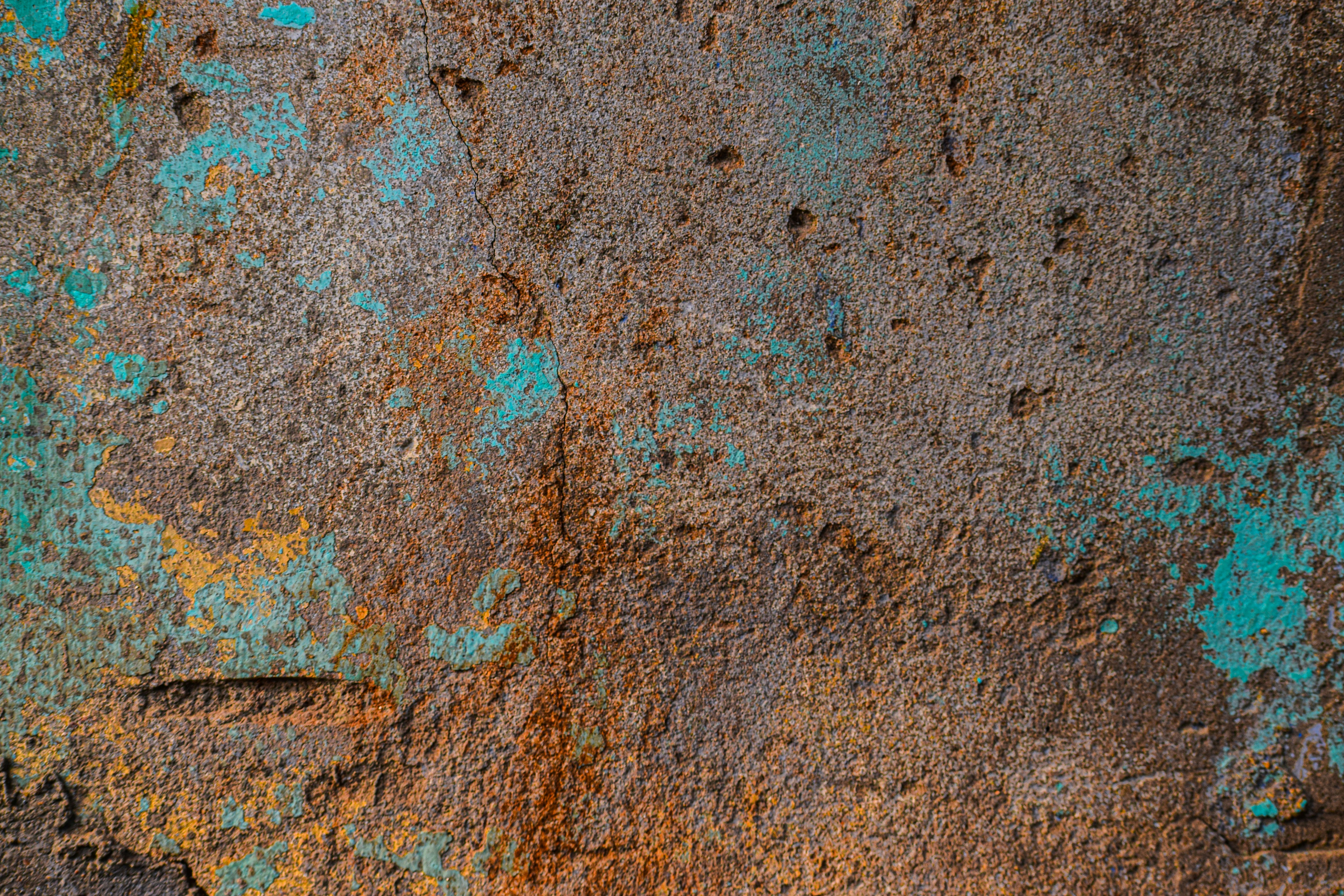 Close-up of weathered, rusty metal with teal paint