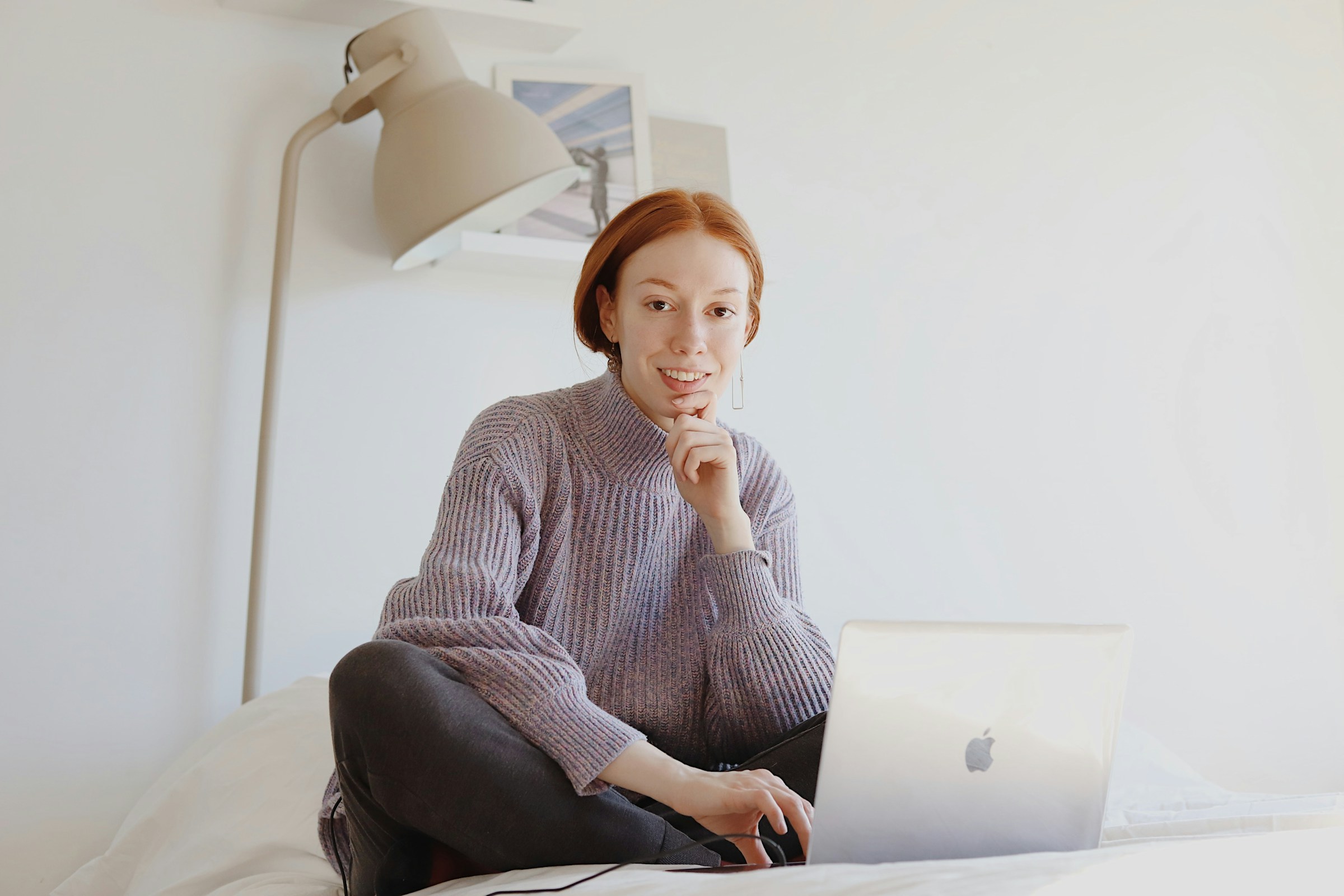 woman sitting on bed alone - Best AI For Writing Essays