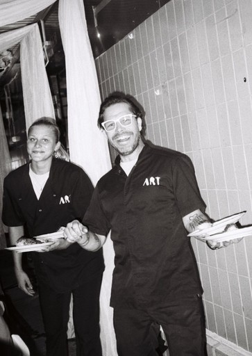 A man and a woman sitting at a bar