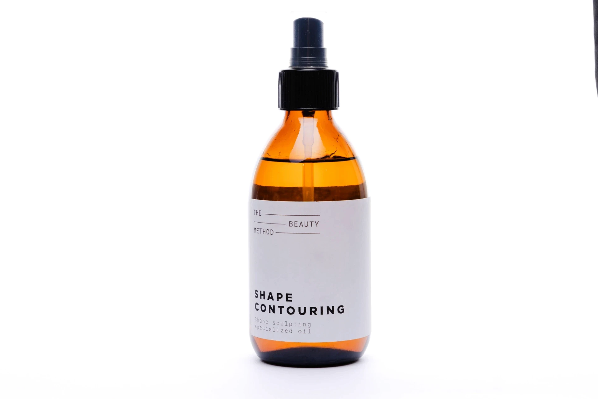 Amber bottle of Shape Contouring oil. Freelance brand identity designer Barcelona.