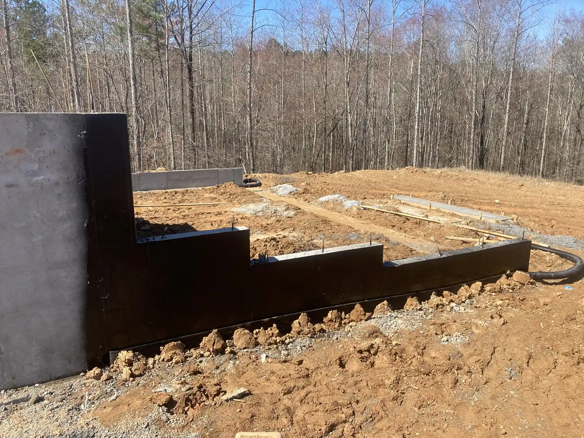 Rub-R-Drain at the footing of a new concrete foundation that also has asphalt damp proofing applied