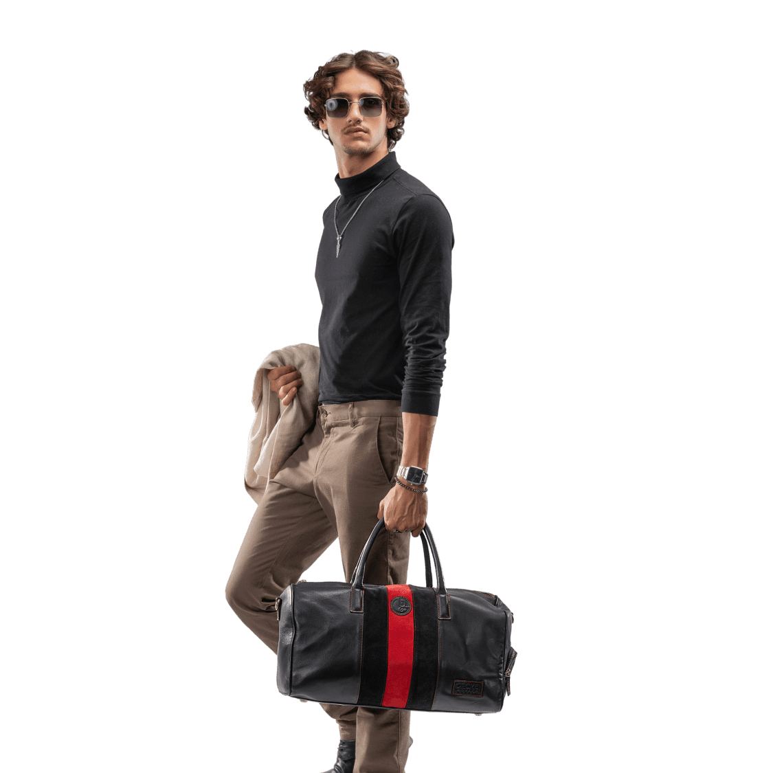 Man holding a black duffel bag with a red stripe on a white background