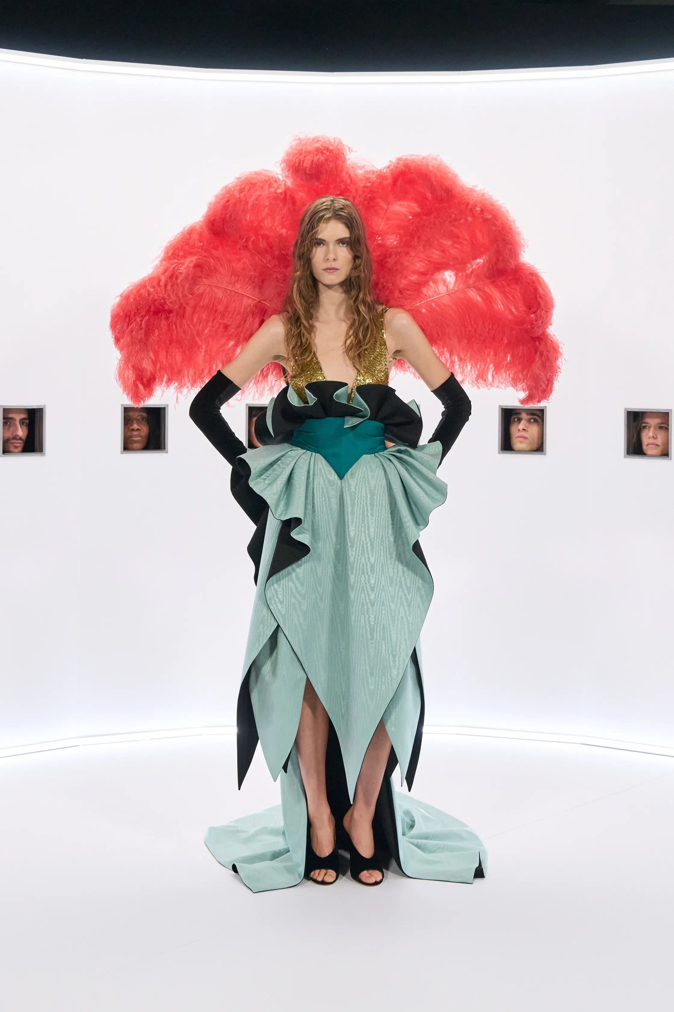 View of the French countryside through a stone villa’s open living room, with sofas and trees framing the scene