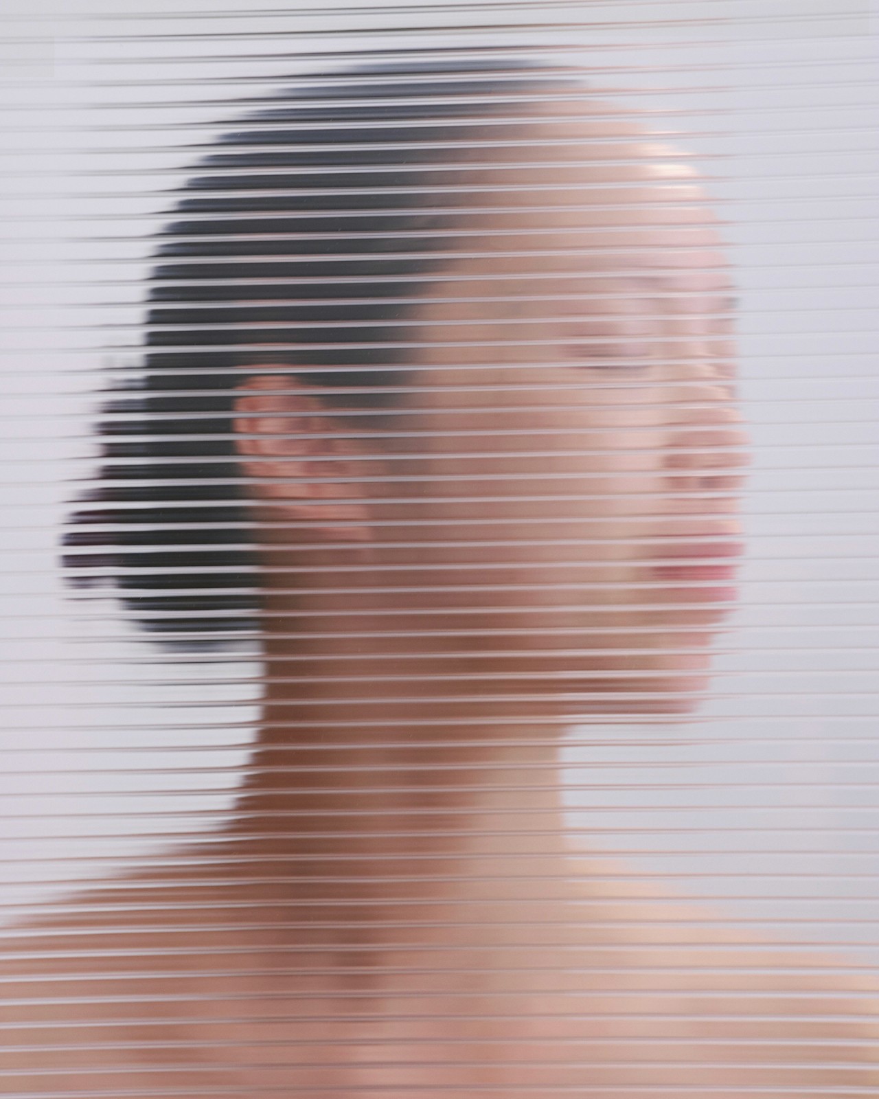 Girl standing behind a glass