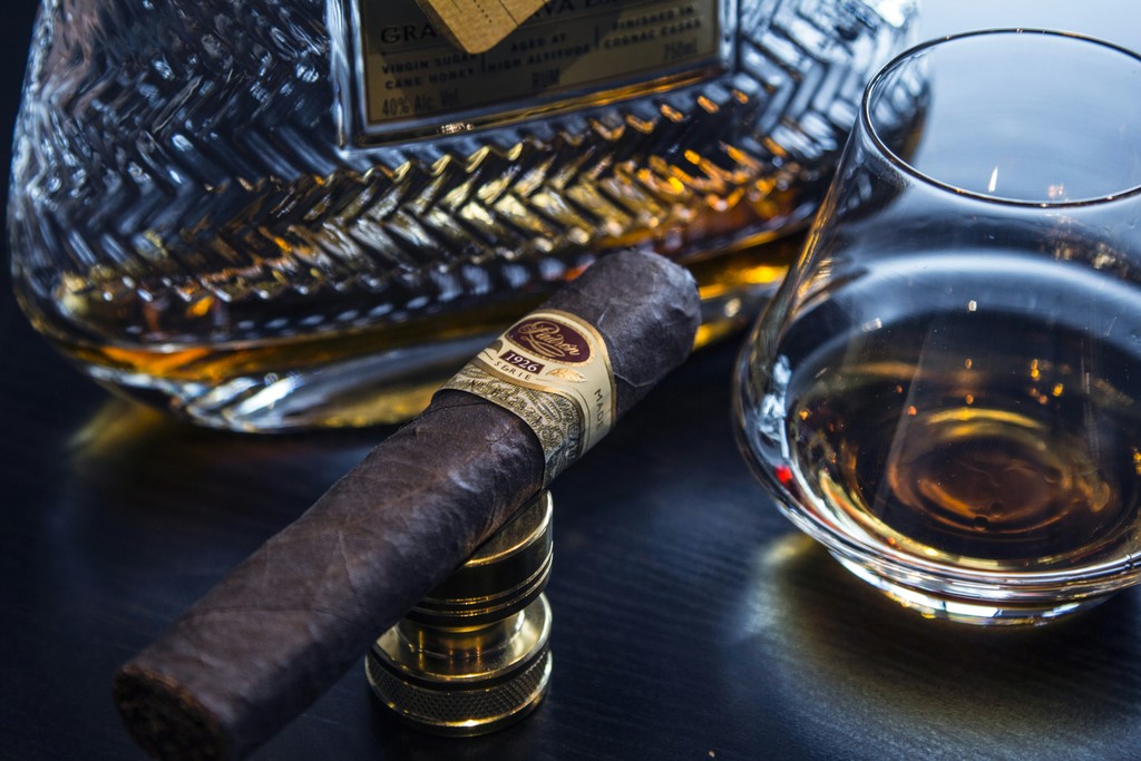 Premium cigar beside a glass of whisky at a private event