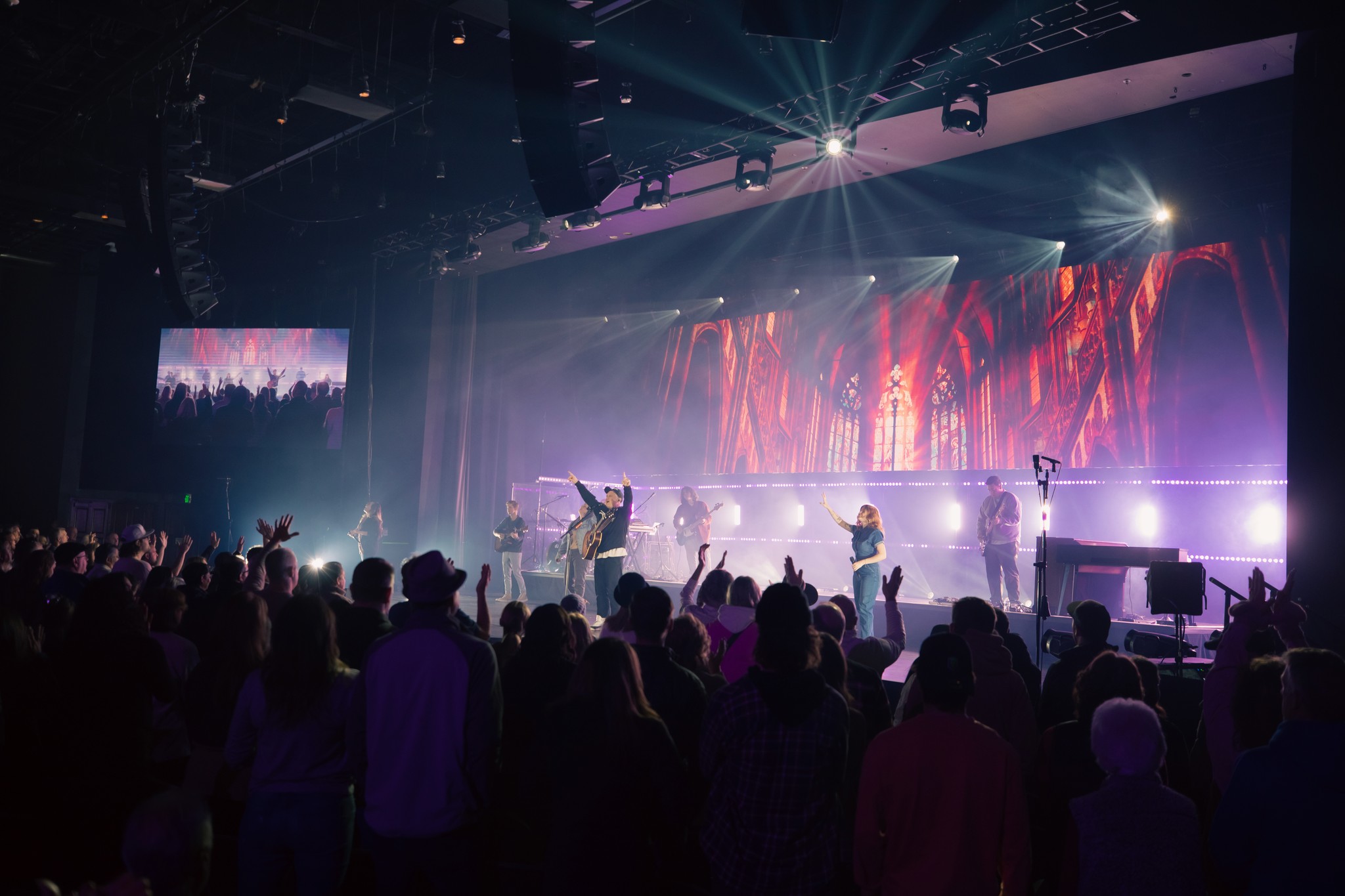 person sitting on grass and using phone