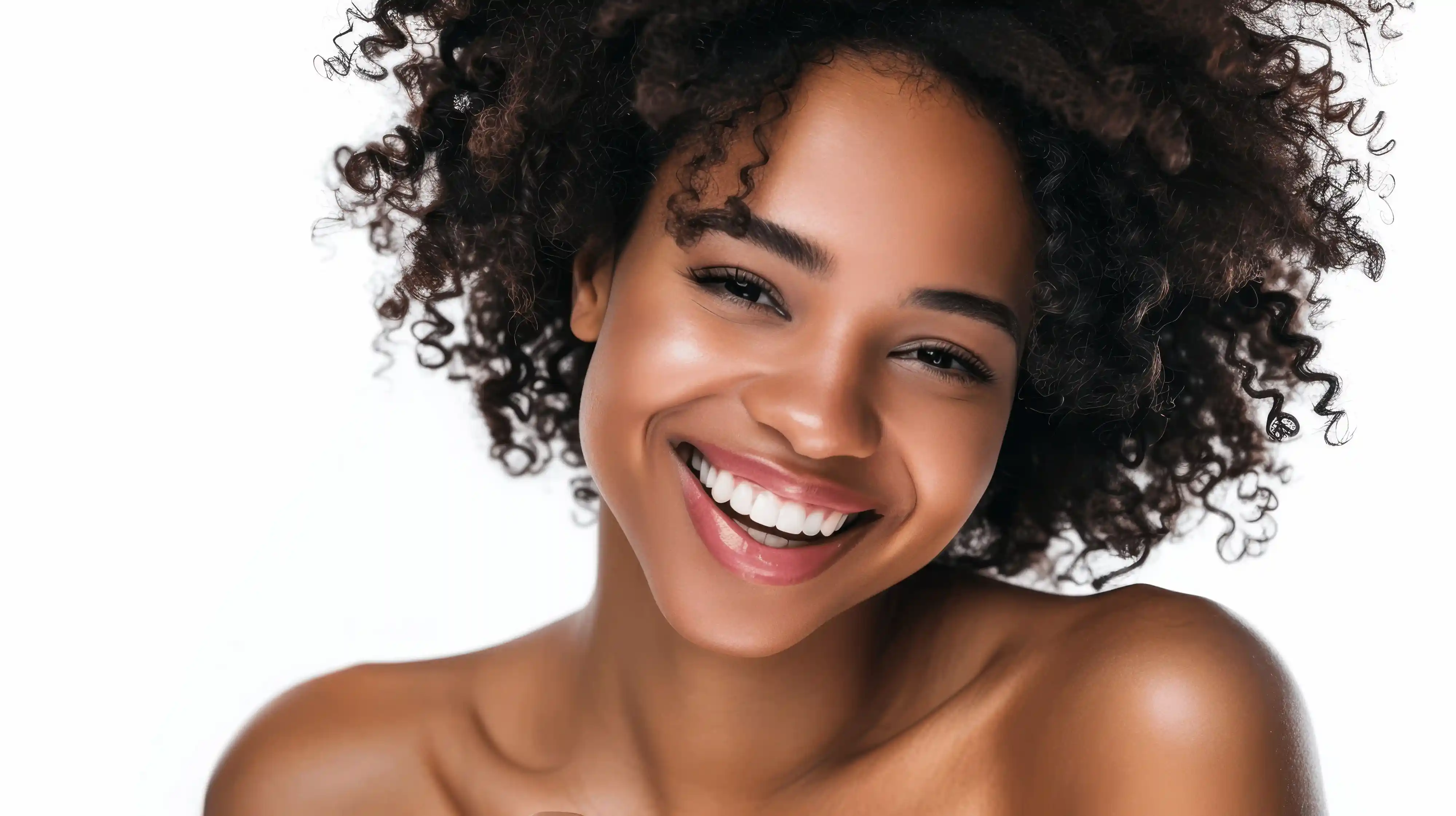 Smiling woman with dark curly hair.