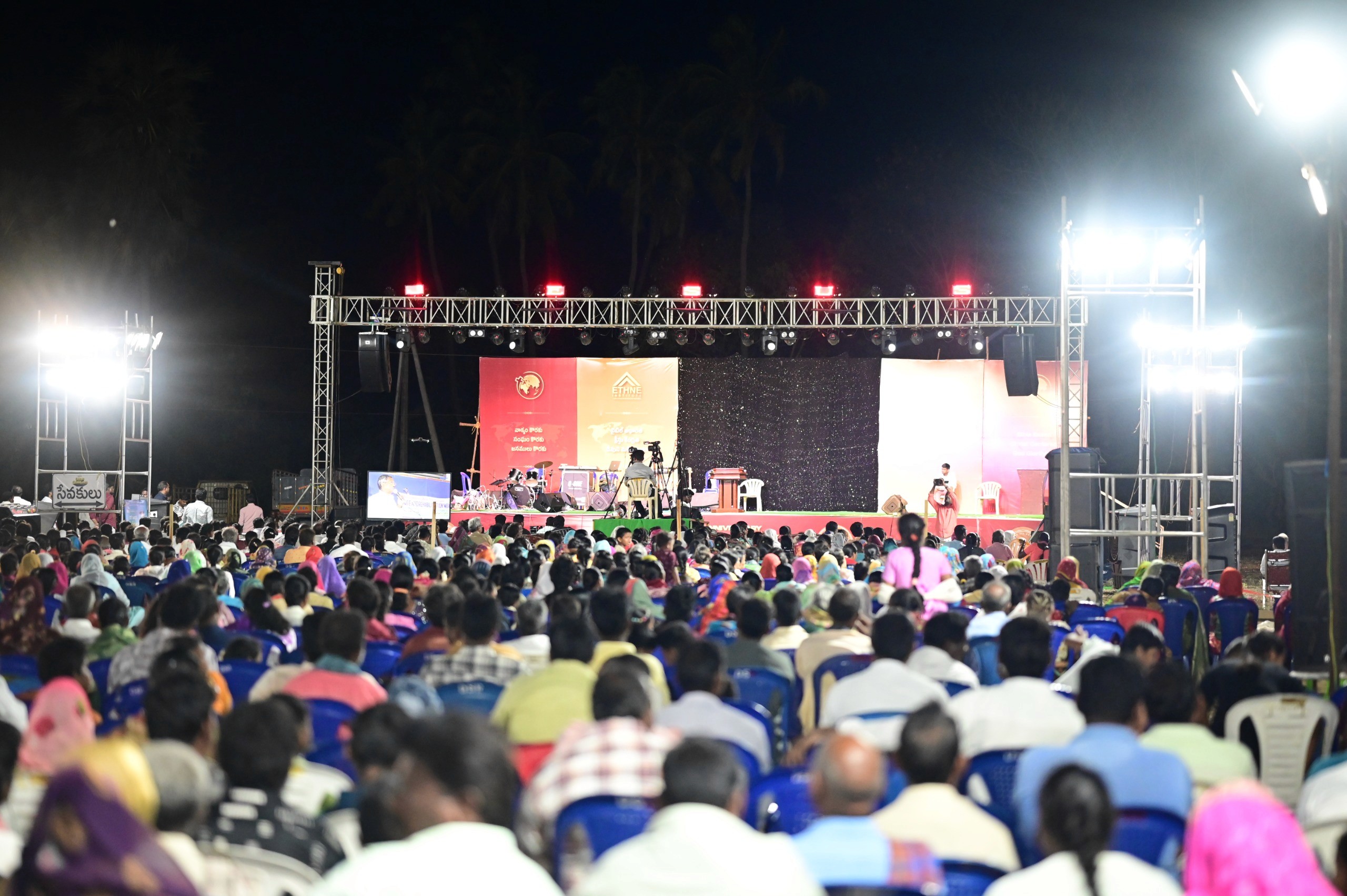 A hand raised in worship during a service in India