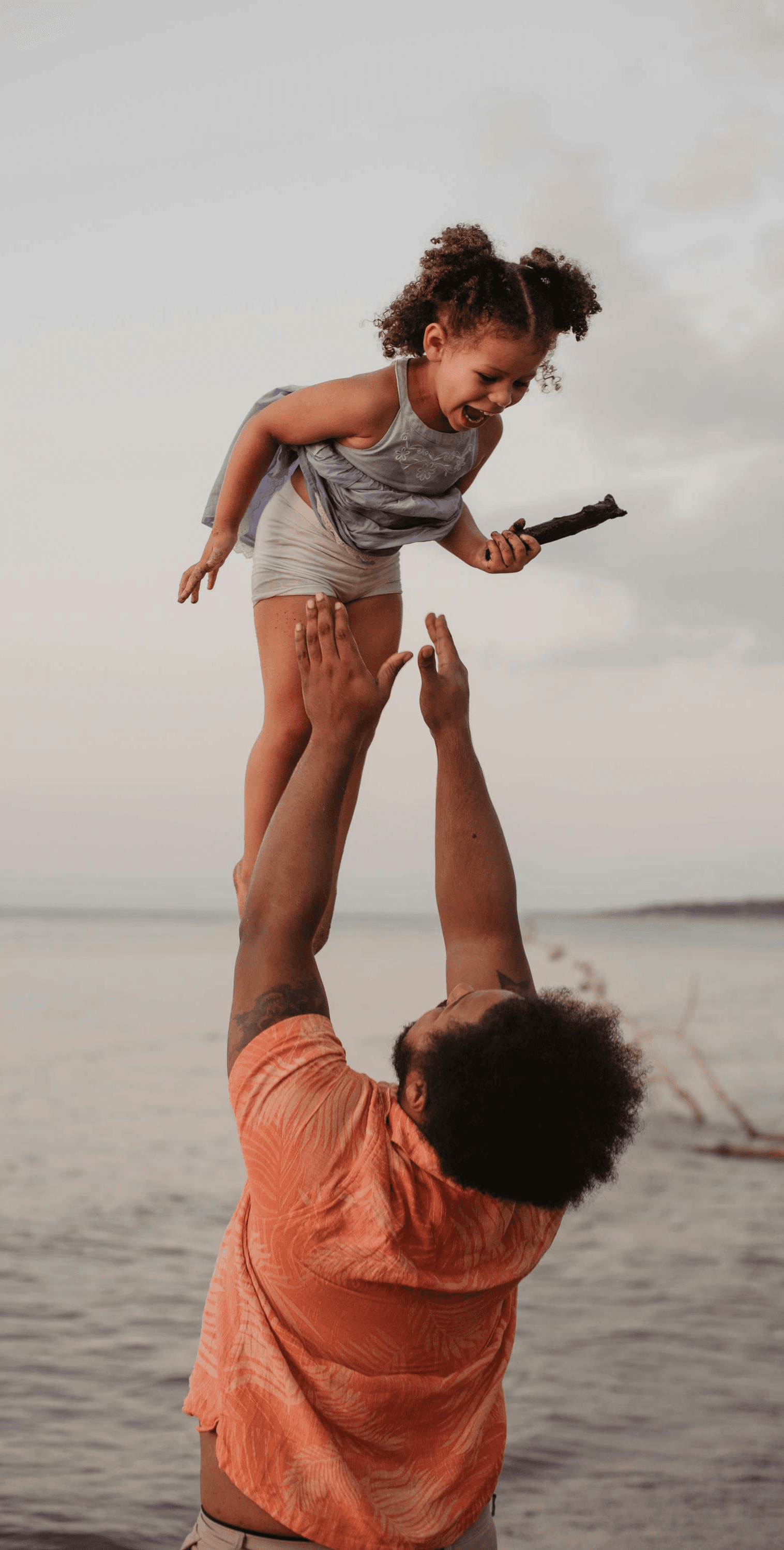 three men and one woman laughing during daytime