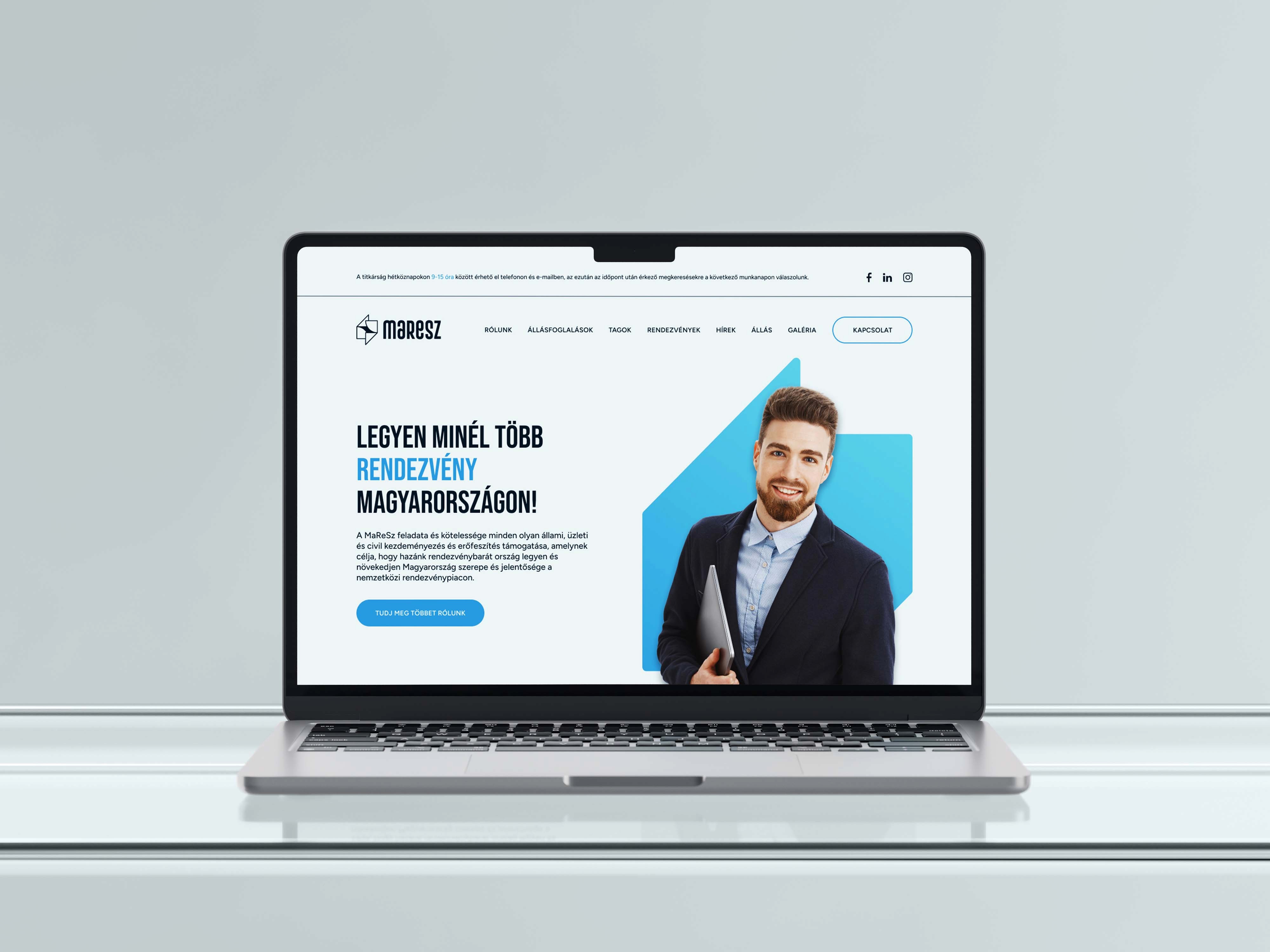 Laptop mockup displaying the homepage with hero banner and smiling professional - MaReSz, an event association brand identity.
