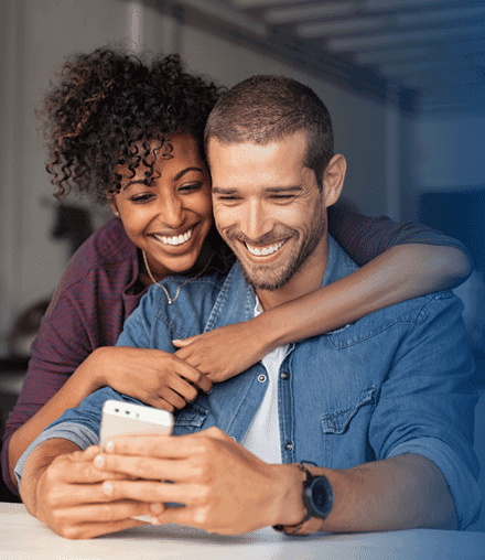 man and women looking at a mobile phone