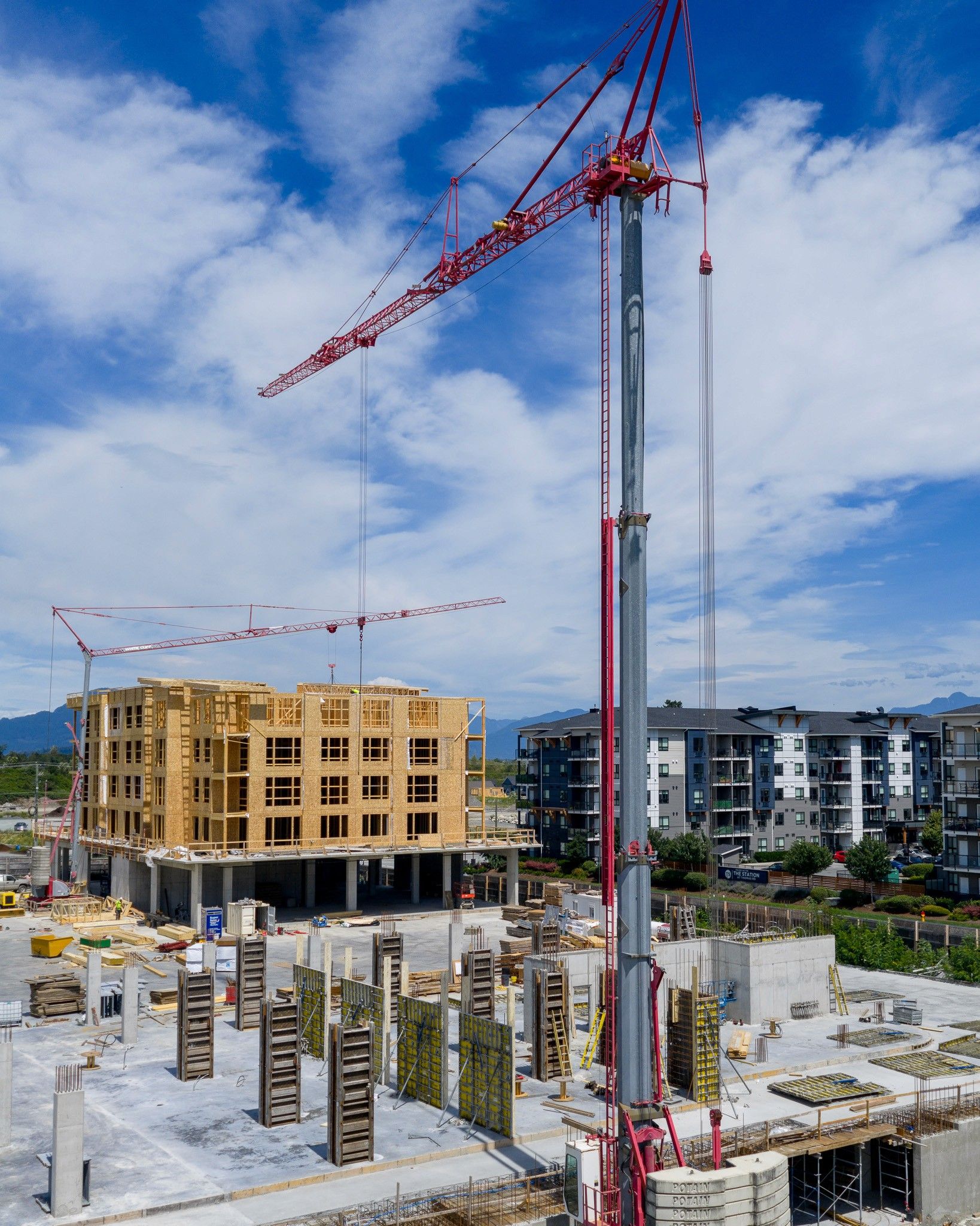 Construction site in Chilliwack, Fraser Valley, British Columbia, with cranes and buildings under development.