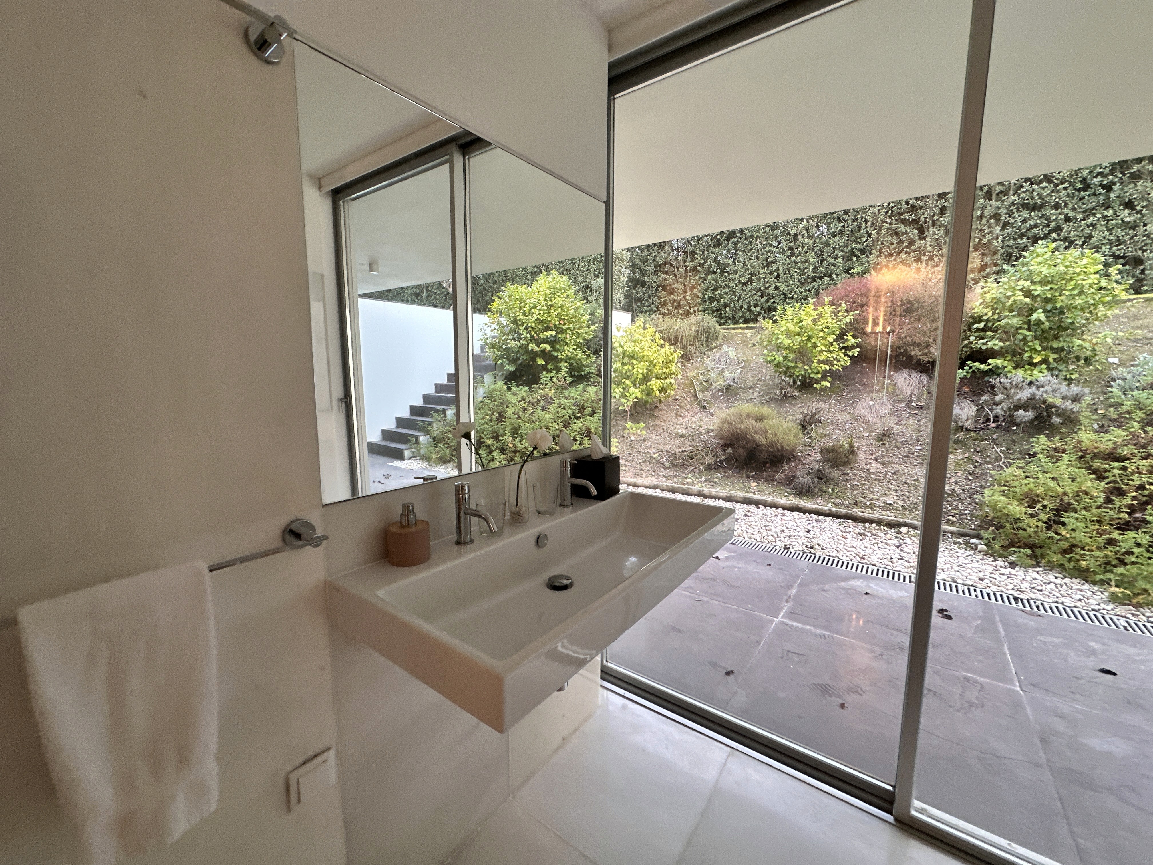 Modern hillside home with terracotta urn and mountain view