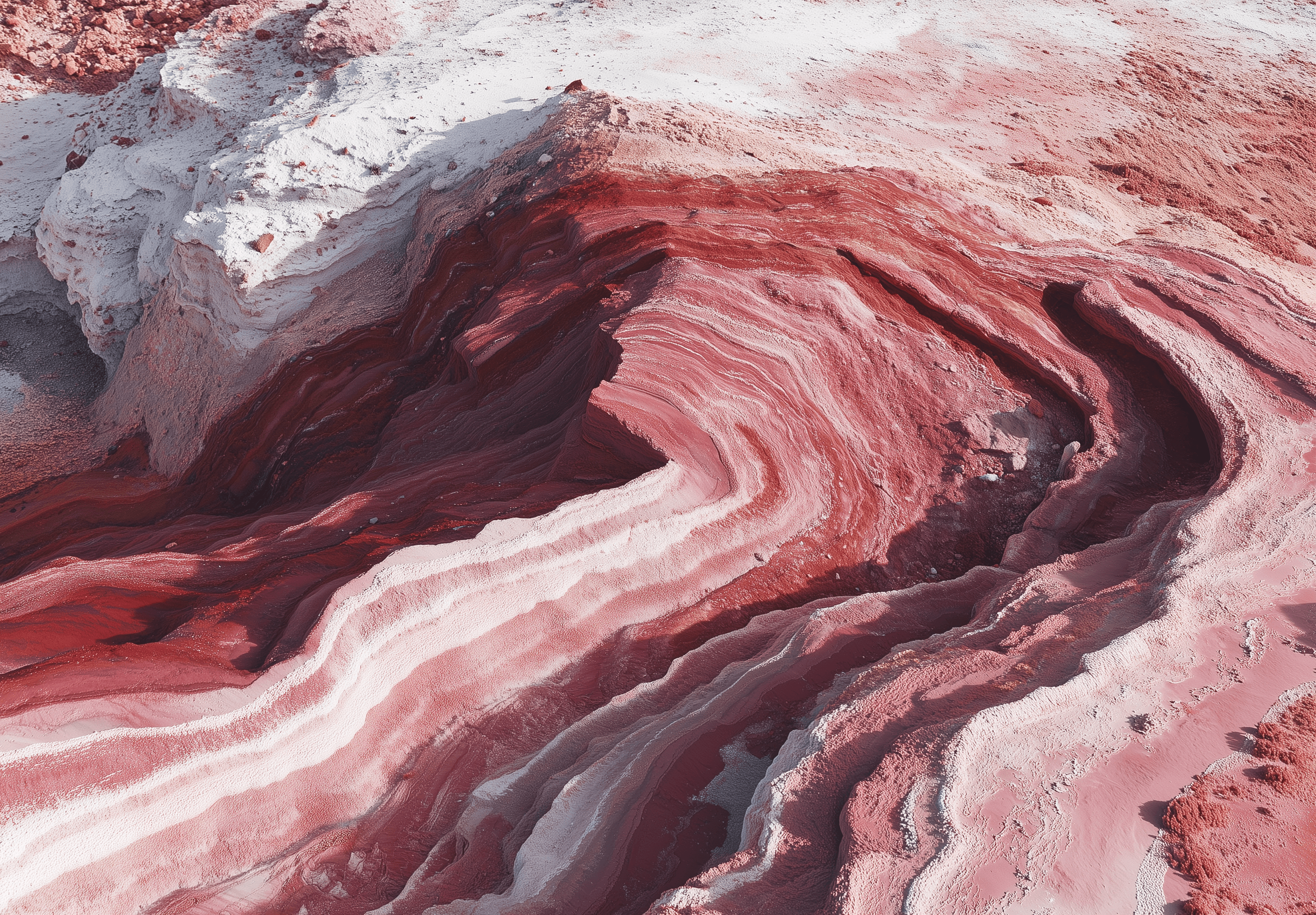 Aerial view of red rock formations in the style of Chinese embroidery, inspired by minimalism and nature-inspired installations, against a white background, captured through aerial photography, featuring pastel colors, organic shapes, smooth curves, and colorful layered forms, with a top-down perspective and a wide-angle lens, showcasing the red desert rocks with various shades of pink rock formations.