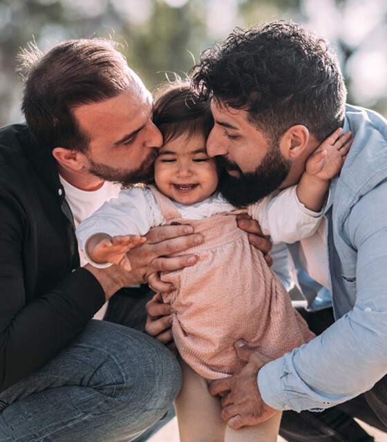 two men and their baby girl