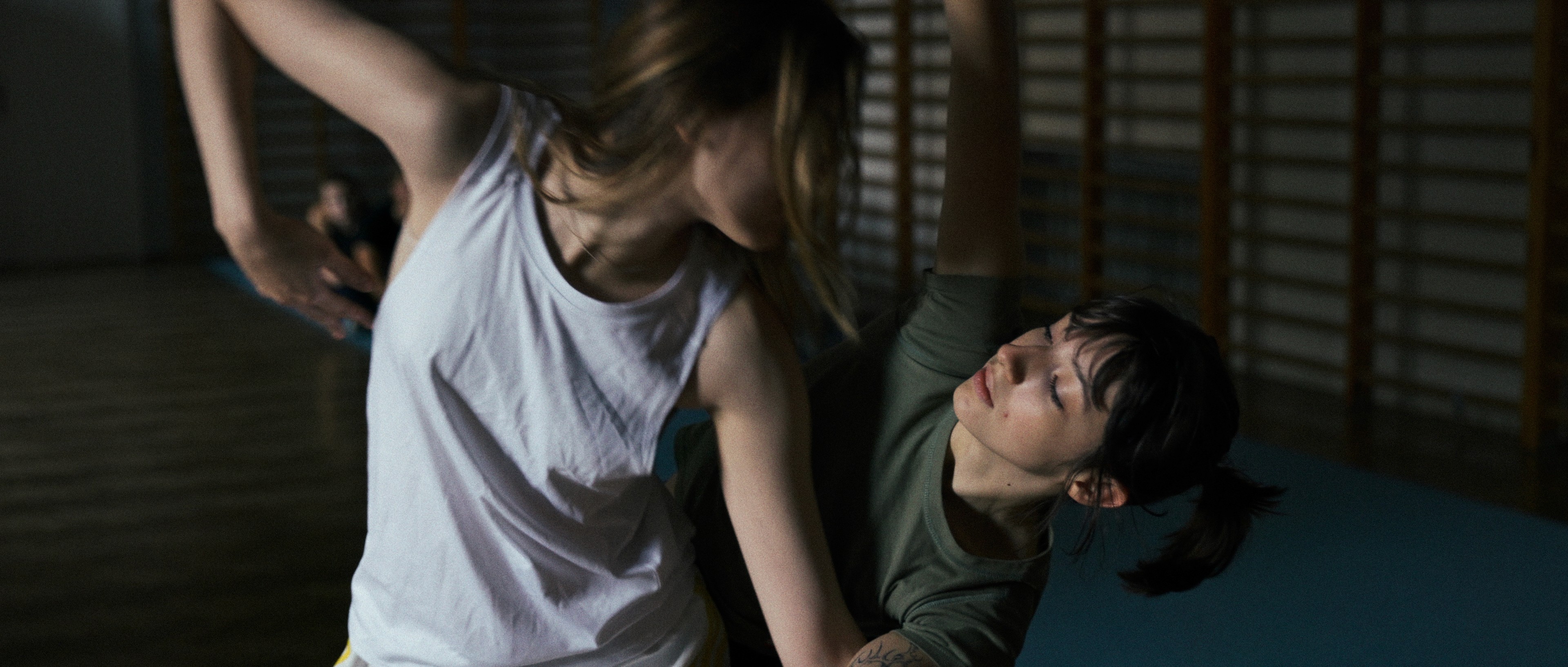 Two actors performing a movement scene, dynamic camera angle.