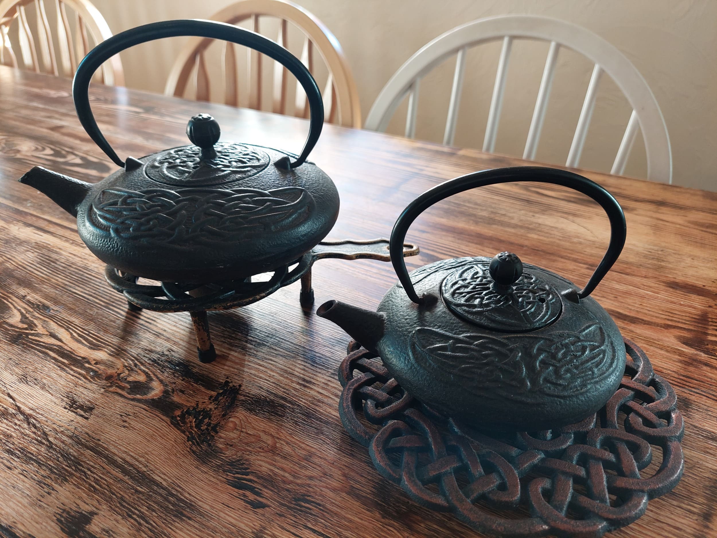Cast-iron teapots on table inside