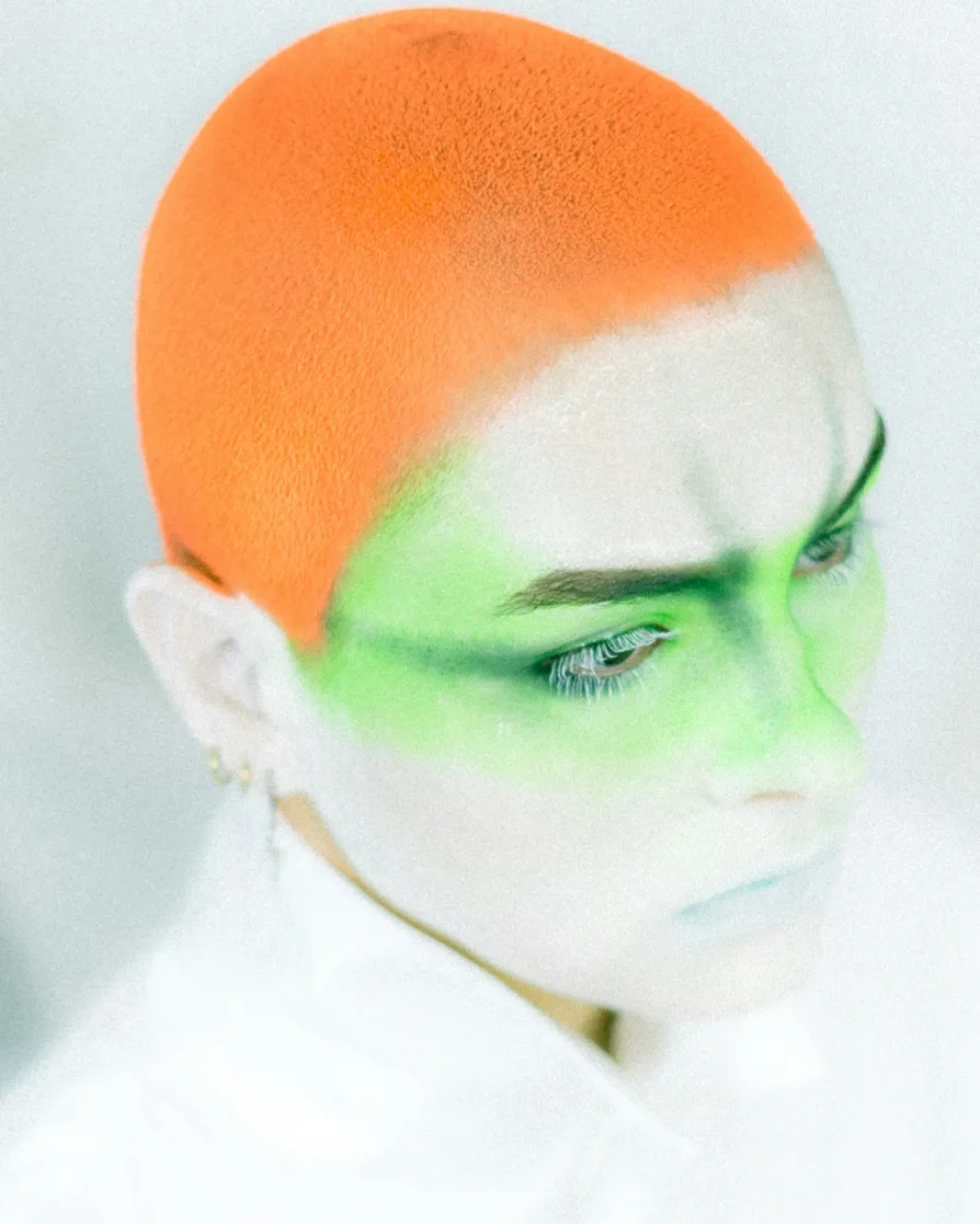 a person with a green face and a white background