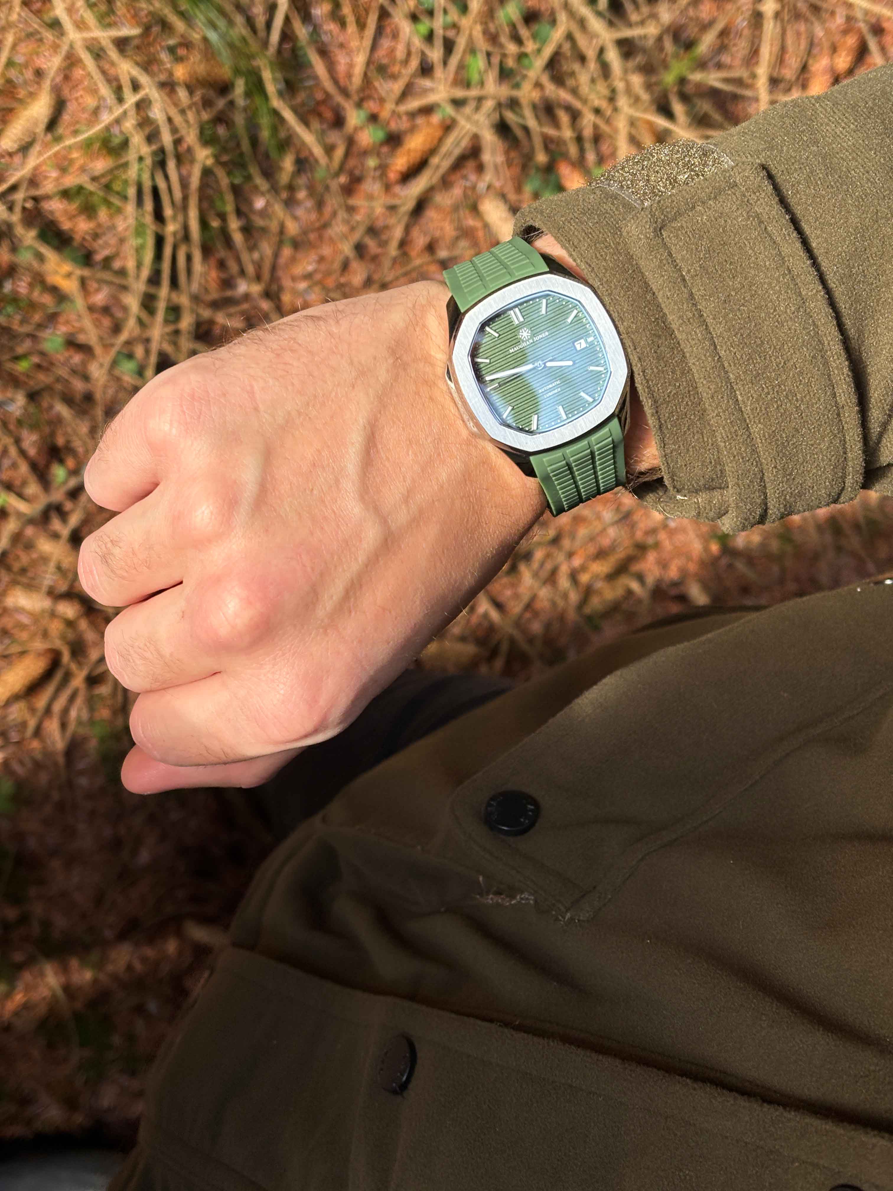 woman waering a neon green jacket sitting on stairs
