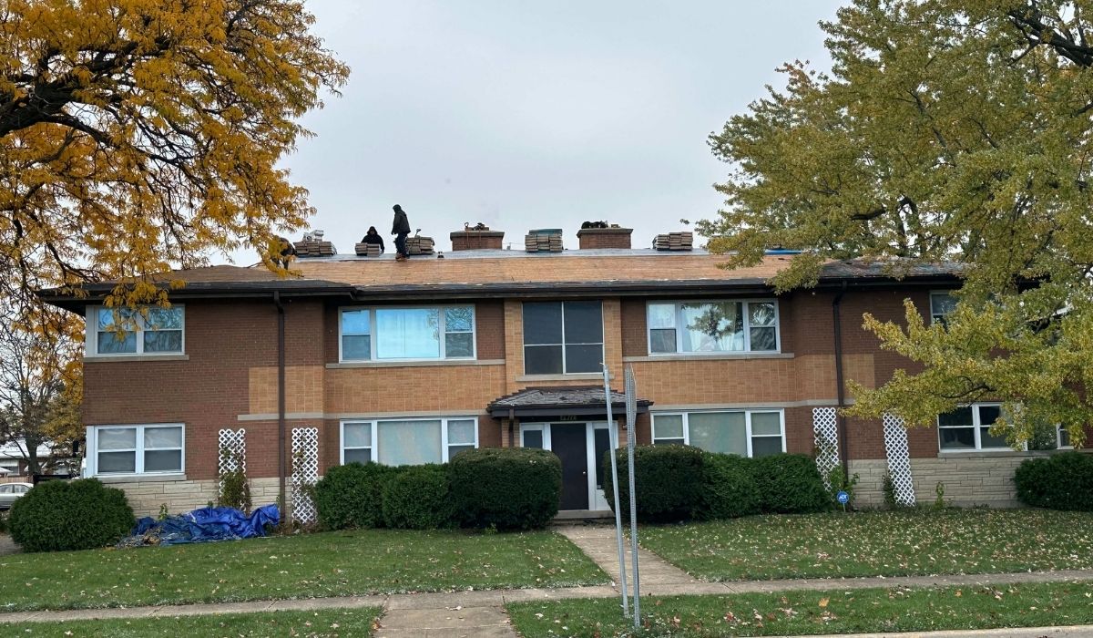 Original job-site photo showing roofing work underway on an Illinois property during fall, with visible autumn foliage and roofing materials on the roof. Used as the featured image for the article about fall roof replacement timing in Illinois.