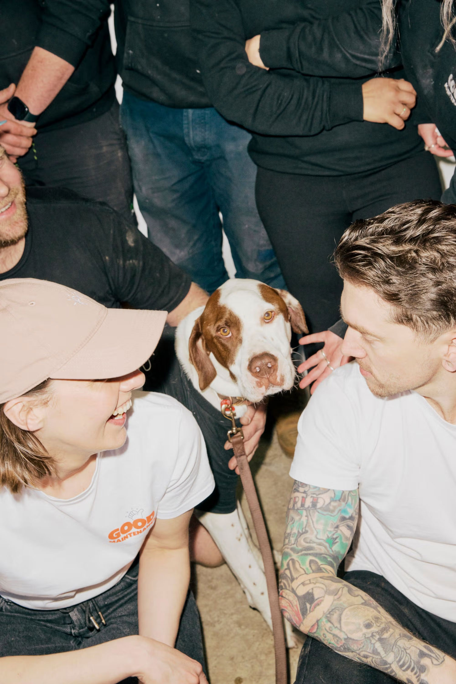 Team gathered together with the company dog in the workshop.