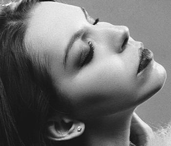 grayscale photography of woman with two hands on her face