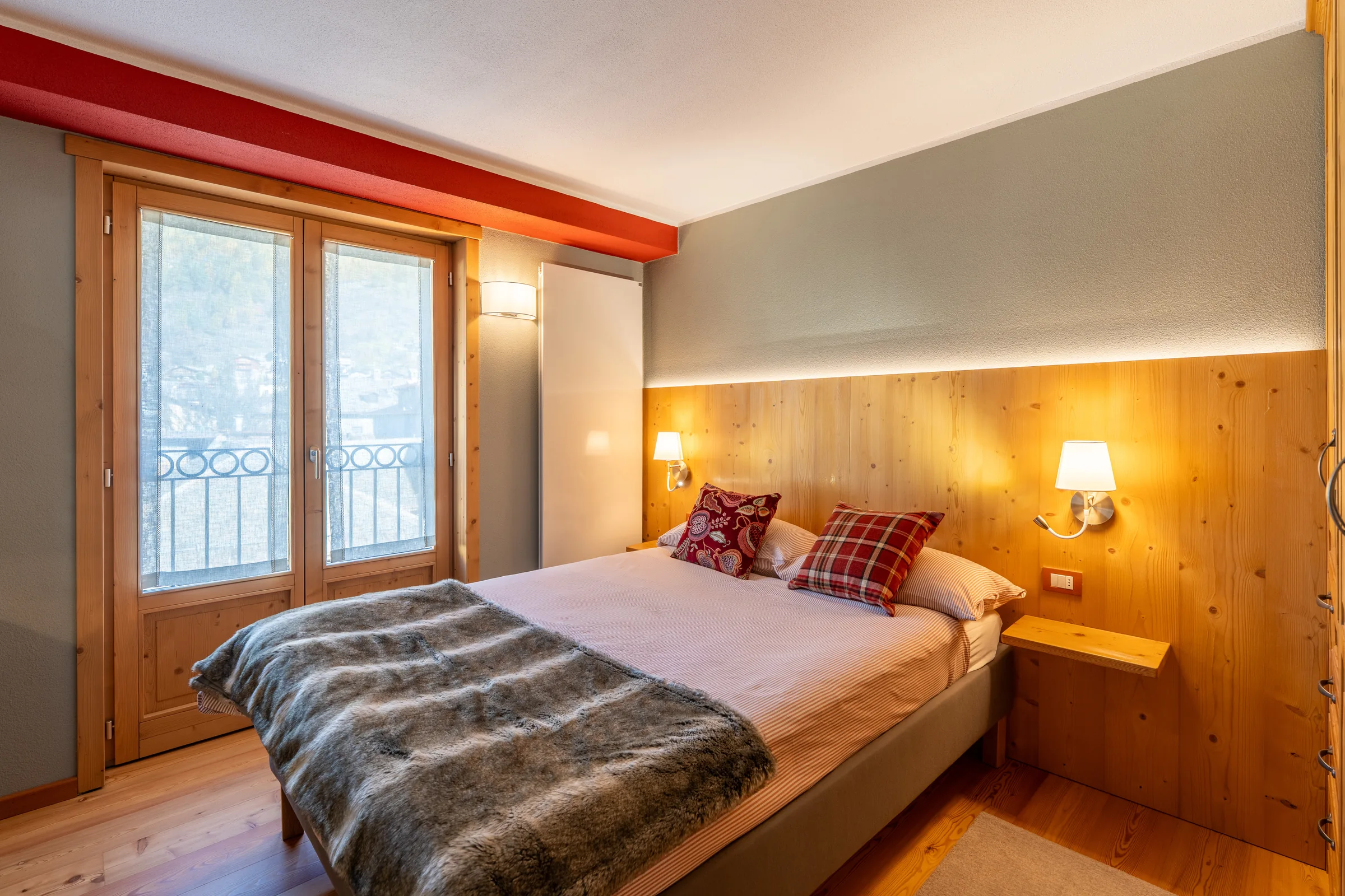 Warm bedroom interior — Bormio & Valtellina, Italy. Photography by Yunes Calore.