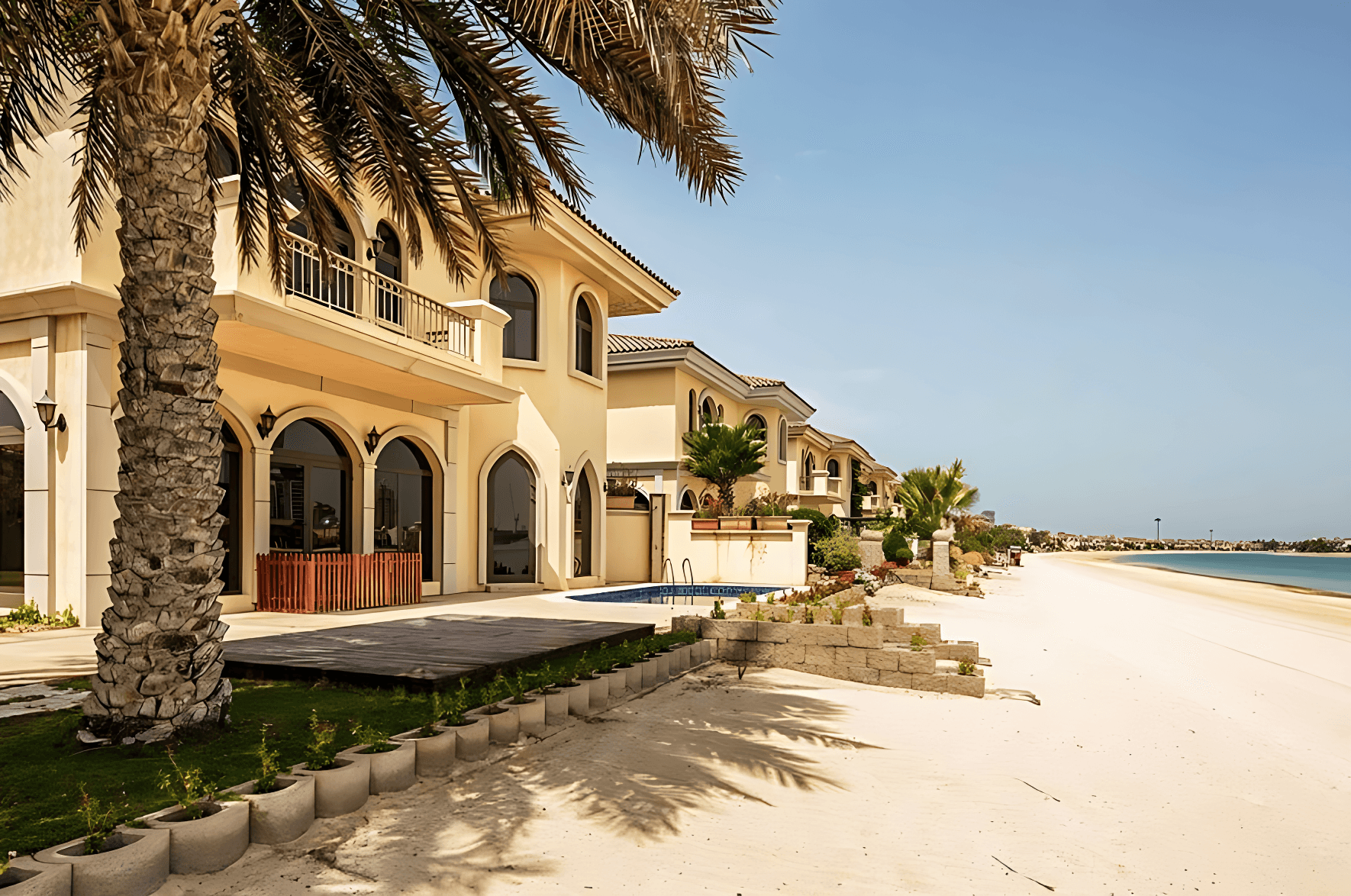 A grand house with steps to the beach, located in a picturesque area of garden homes.