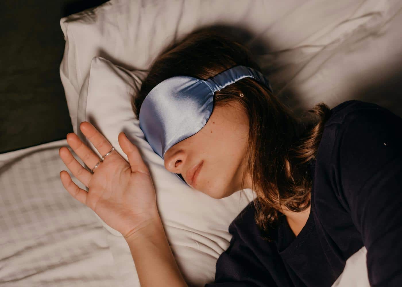 Are sleep masks good for you? Woman sleeping wearing a silk sleep mask