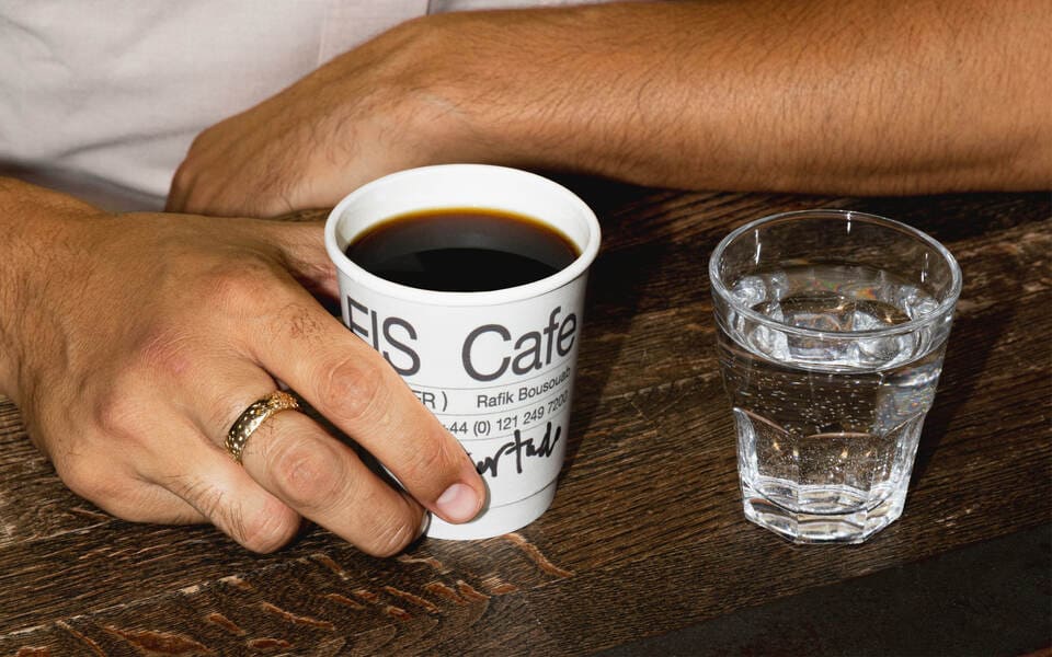 Close-up of a cup of coffee from EIS Cafe with a unique design.